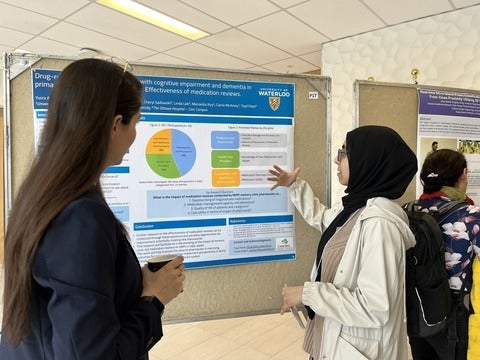 A graduate student explaining their research project