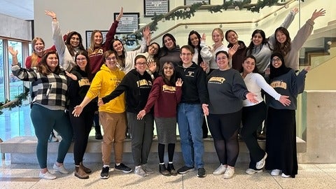 Waterloo Pharmacy students smiling with hands spread out