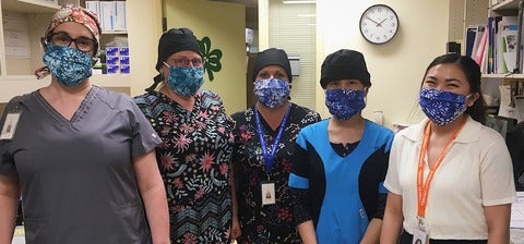 Charin and coworkers wearing masks in the pharmacy department