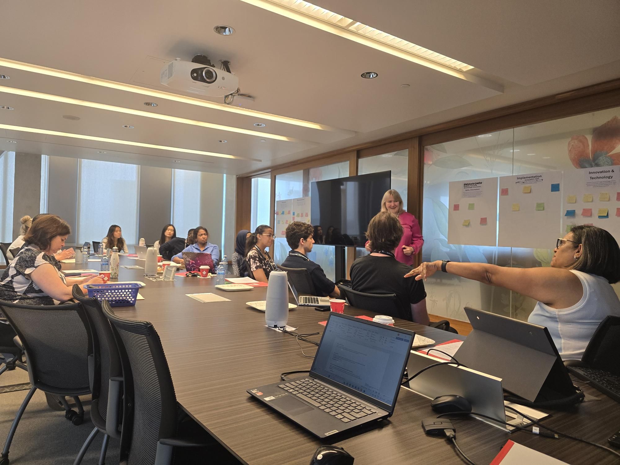 A group of people in a room in discussions
