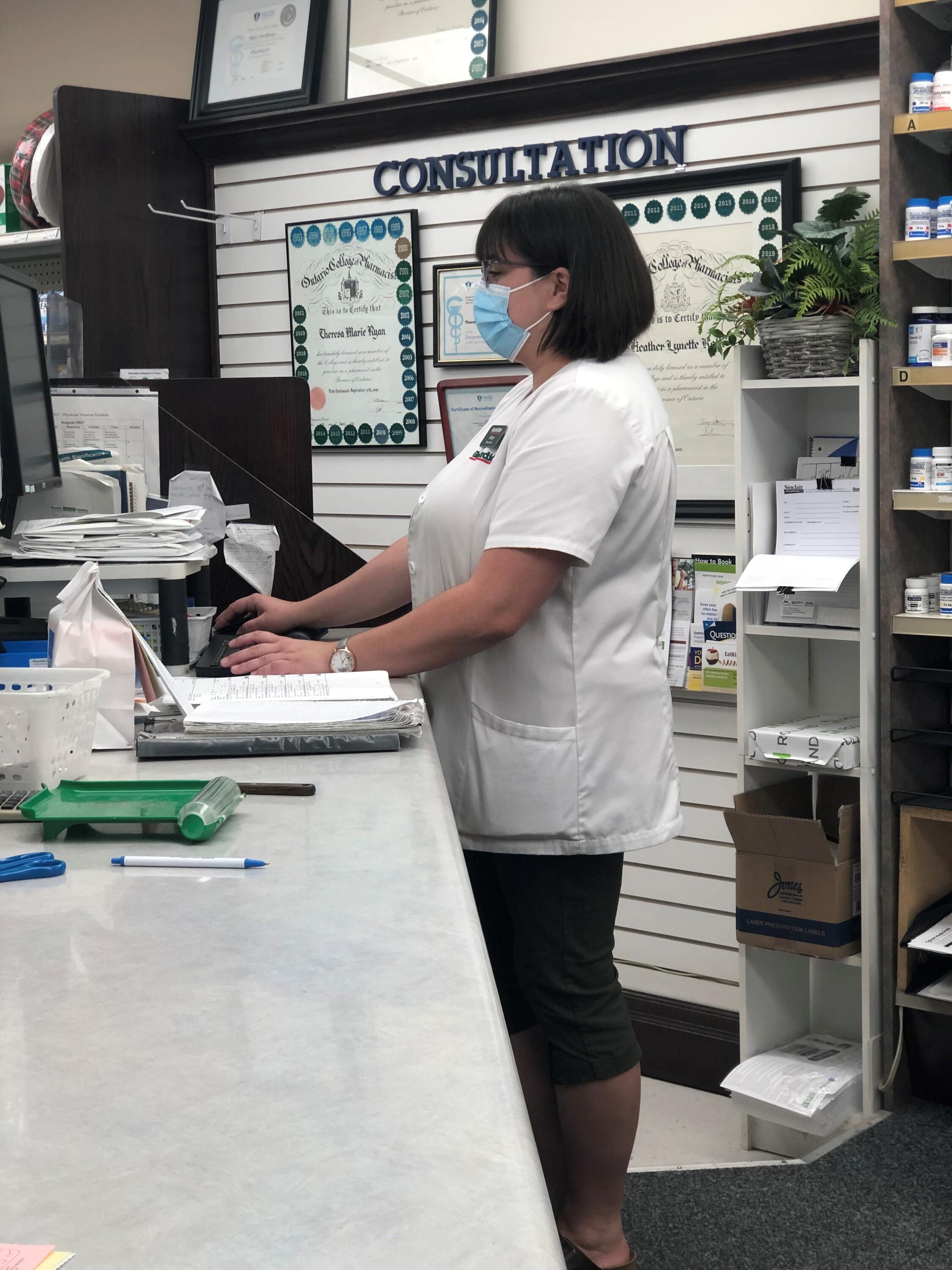 Hilary Bald working in the pharmacy