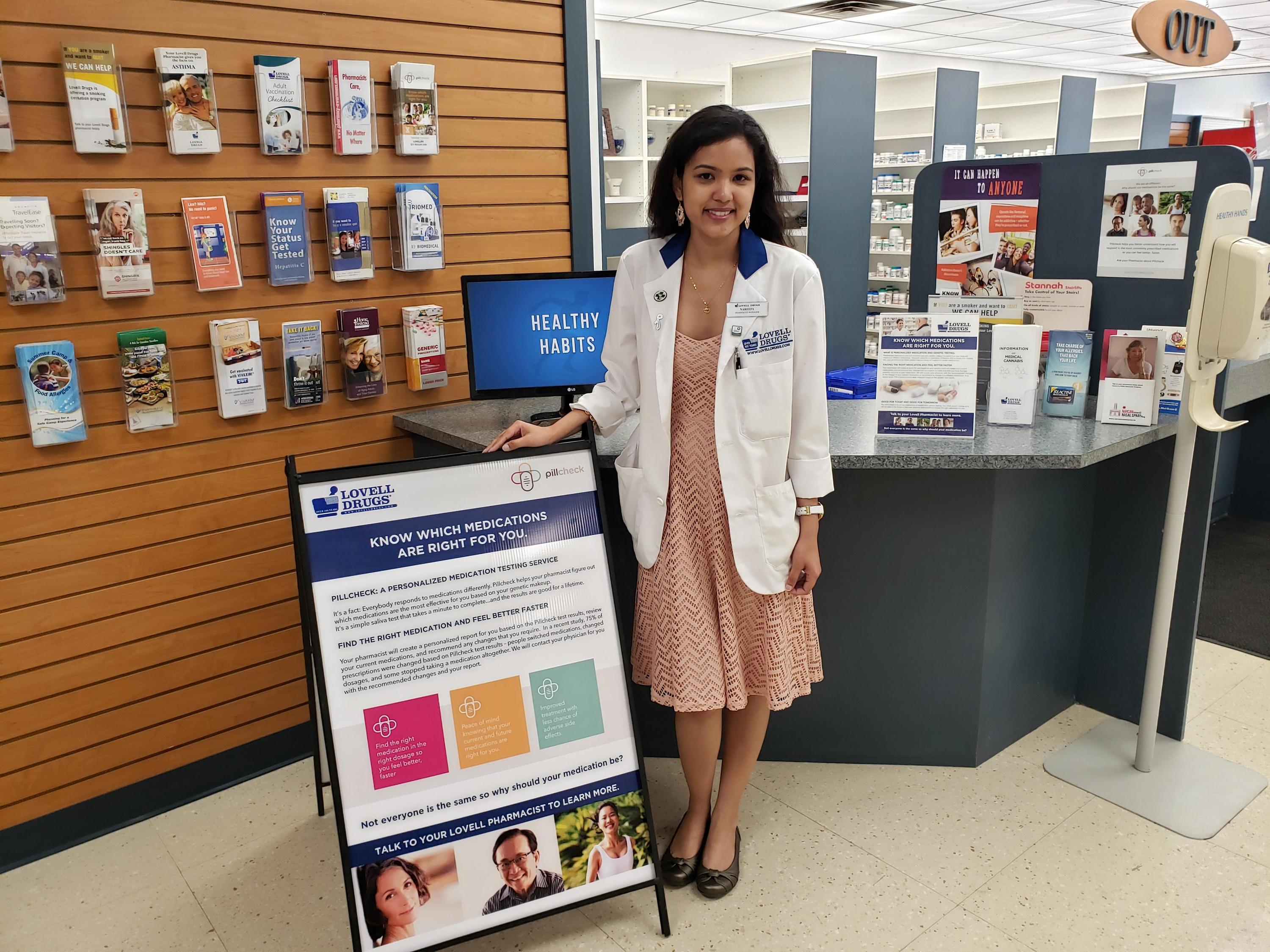 Nareefa standing in front of the counter at her pharmacy in Oshawa