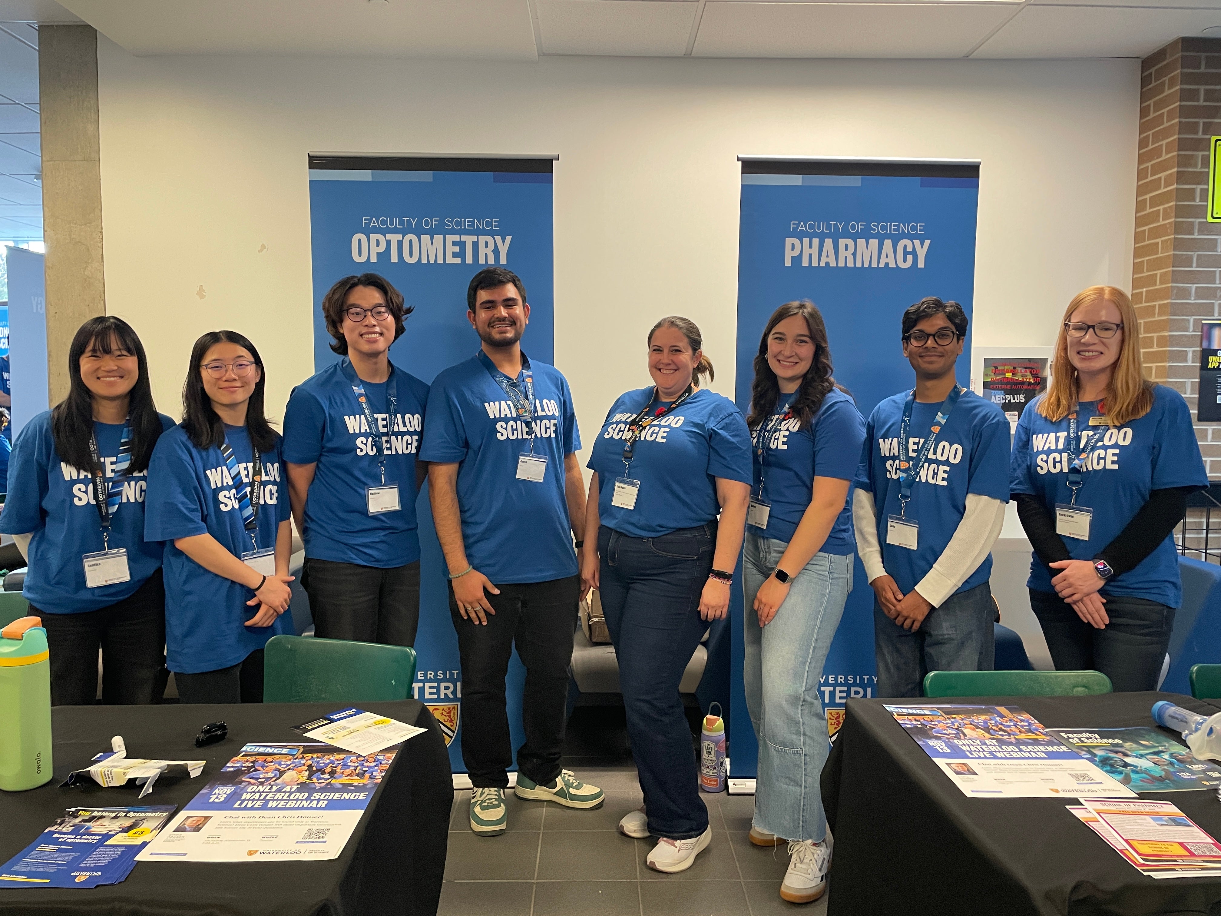 A group of people smiling in Waterloo Science tshirts