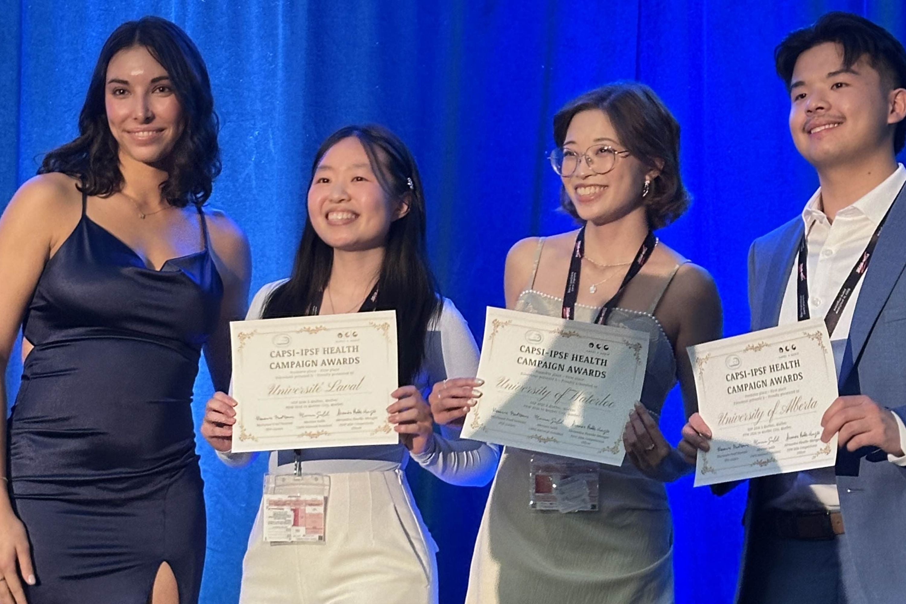 Students holding up awards