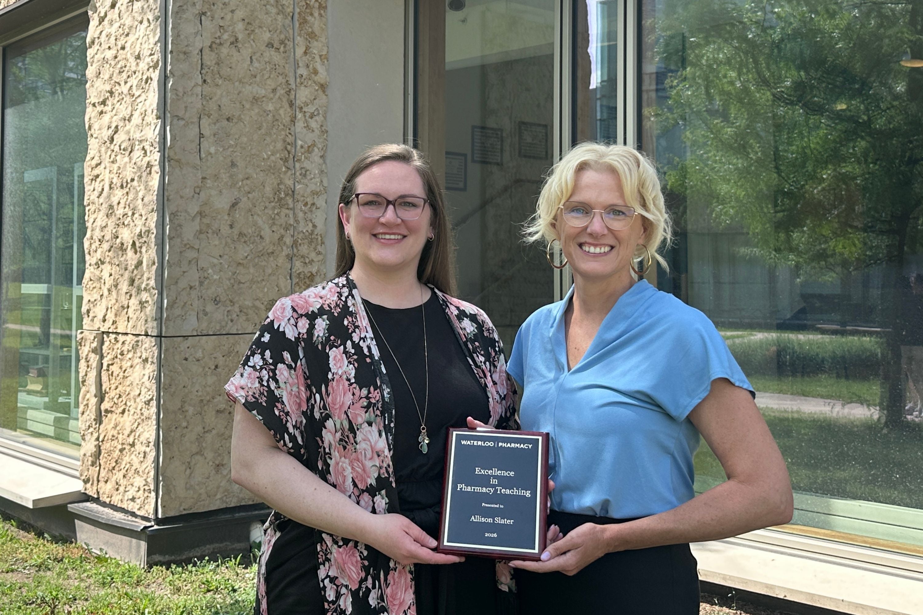 Allison Slater and Andrea Edginton holding an award plaque