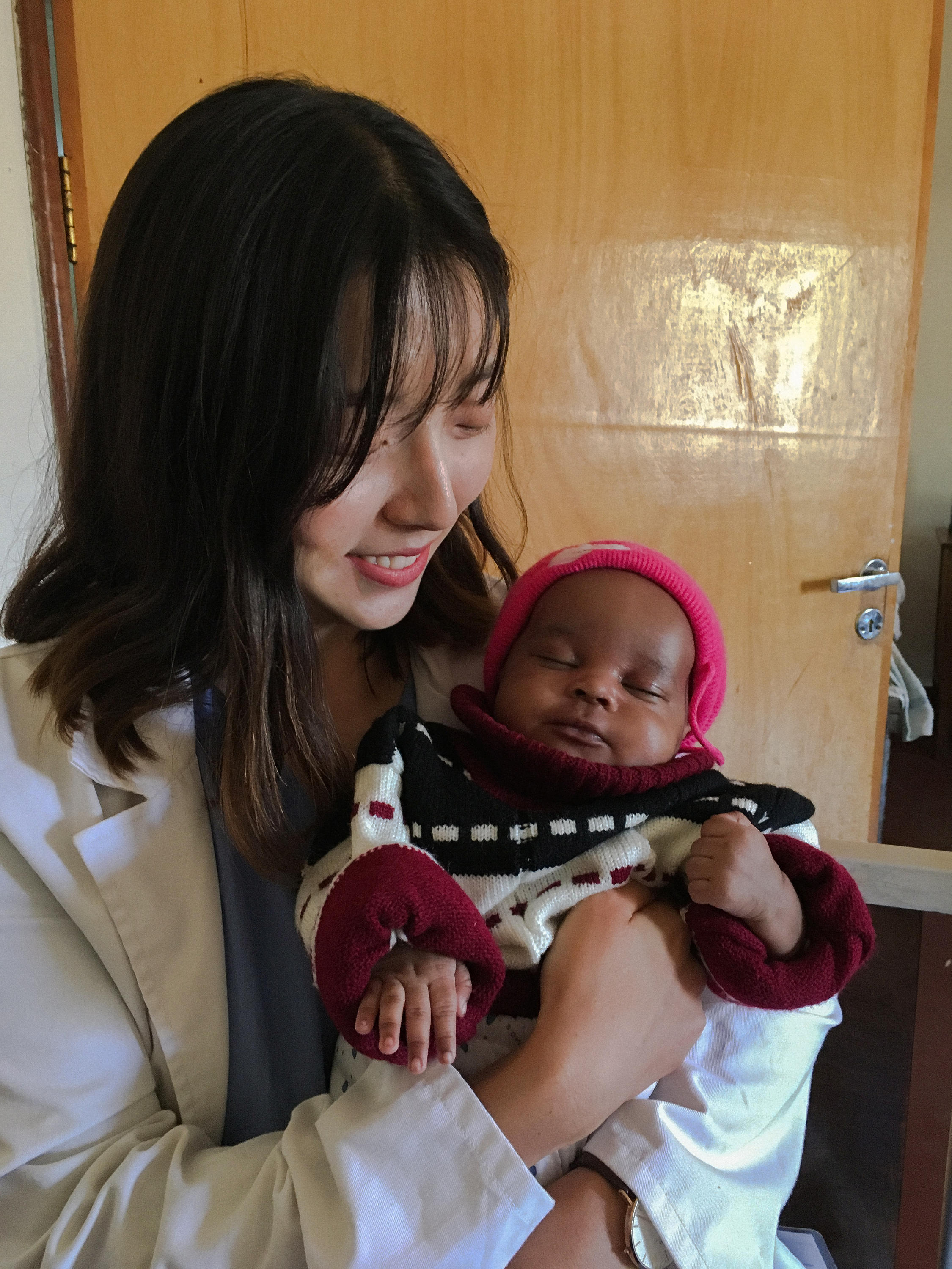 Jung In holding a Tanzanian child