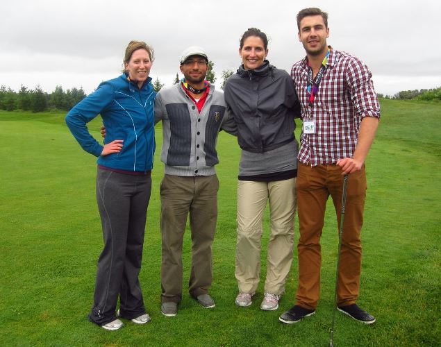 Foursome of studen volunteers on golf course.