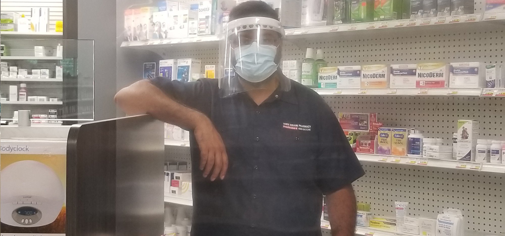 Abhay Patel in PPE inside his pharmacy