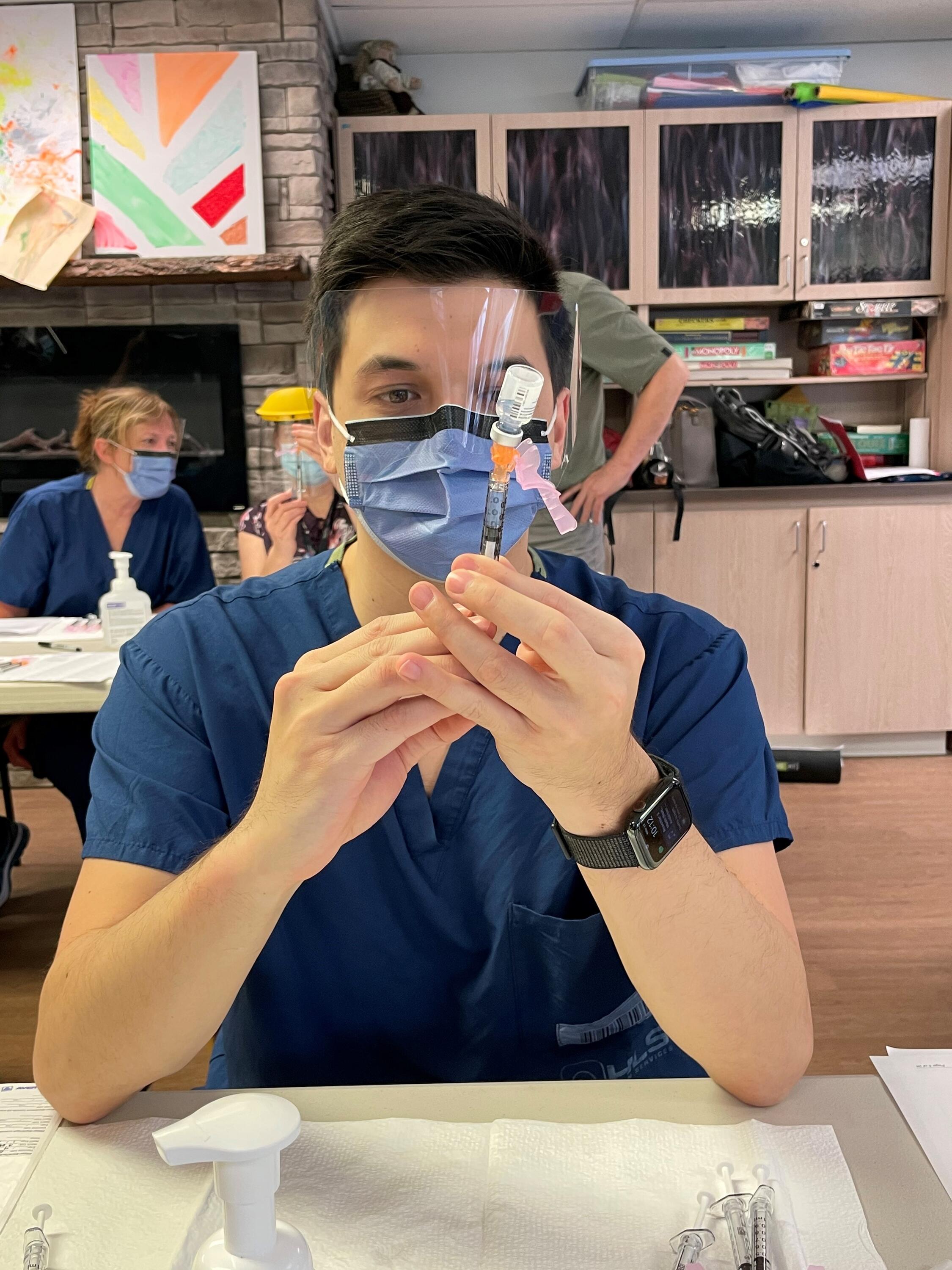 Alex Wong preparing a needle for injection