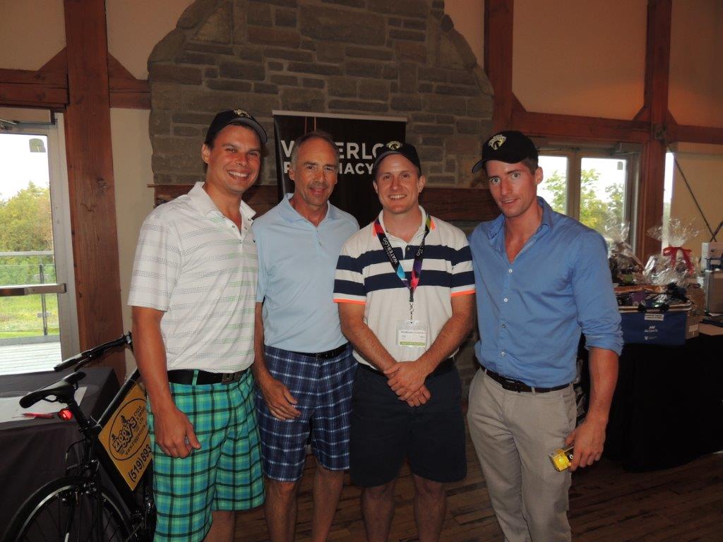Four alumni who won the golf tournament