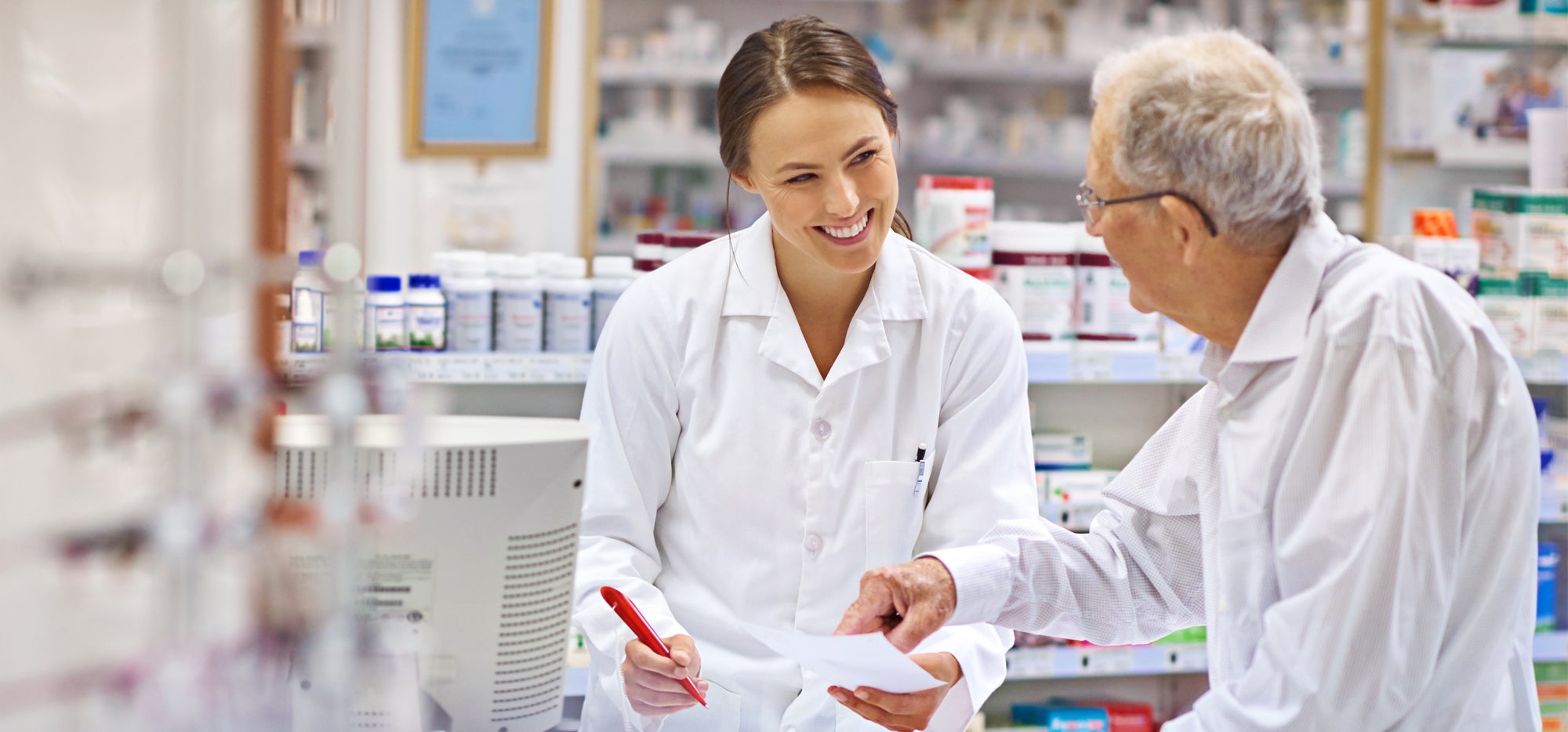 smiling pharmacist talking to patient