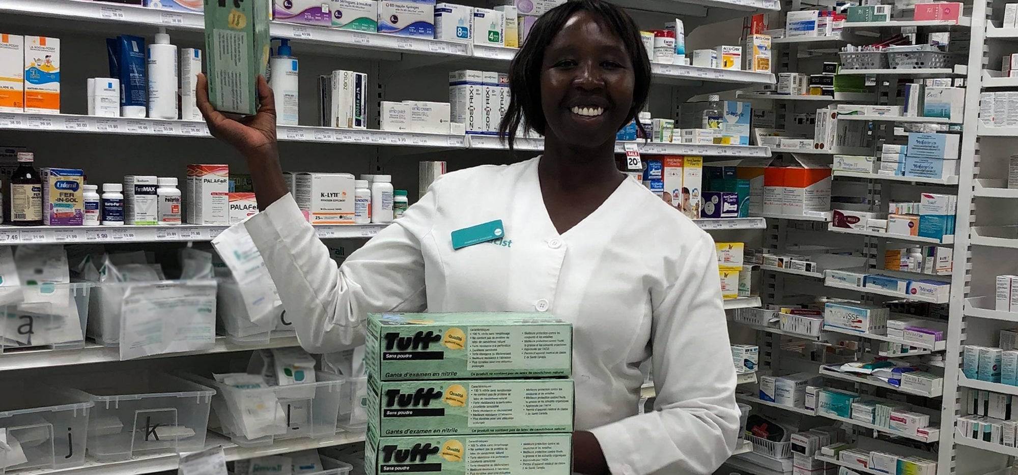 A pharmacist holding up one of the donations Pharm Against COVID delivered to them