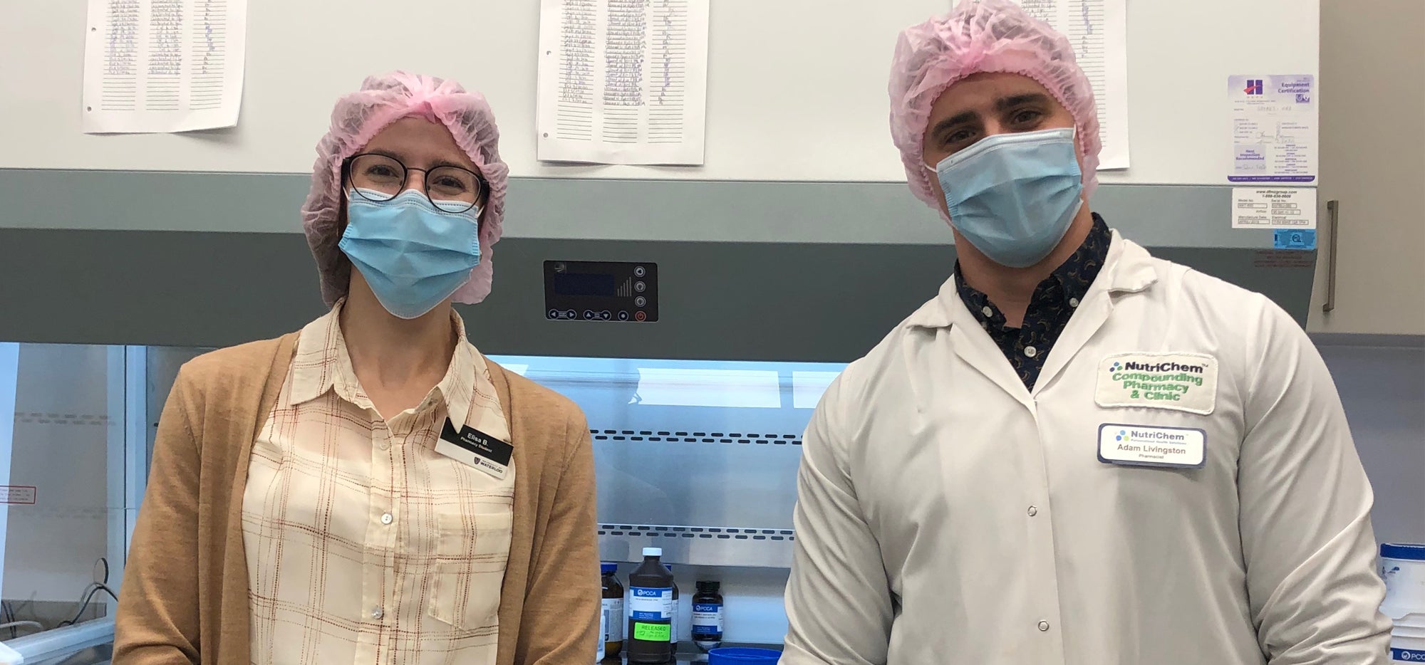Elisa and Adam in the compounding lab wearing masks
