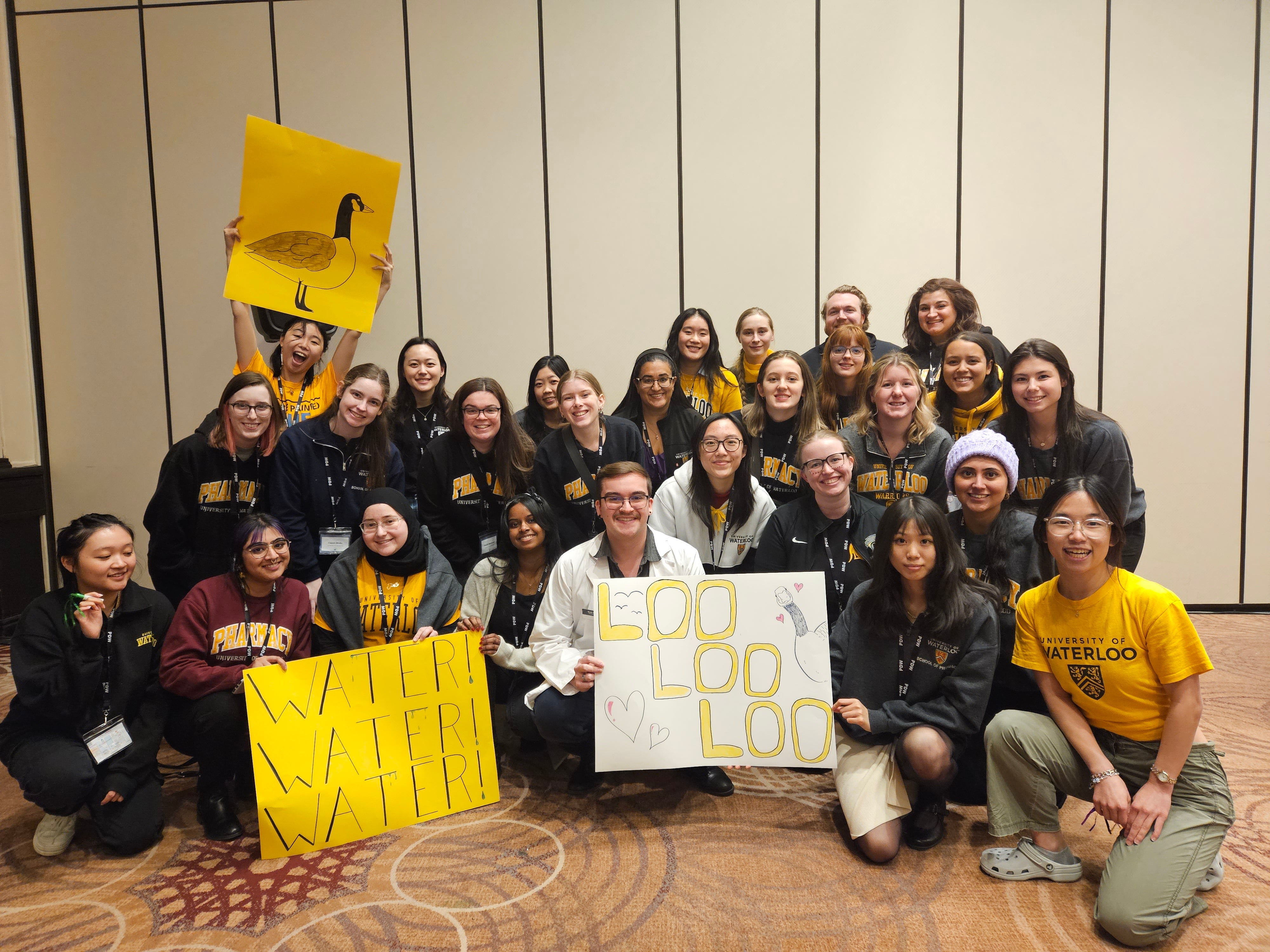 Group of delegates at PD week holding Waterloo signs