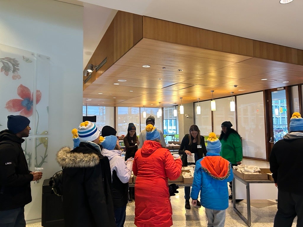 People standing in a line to grab snacks and a beverage in a lobby