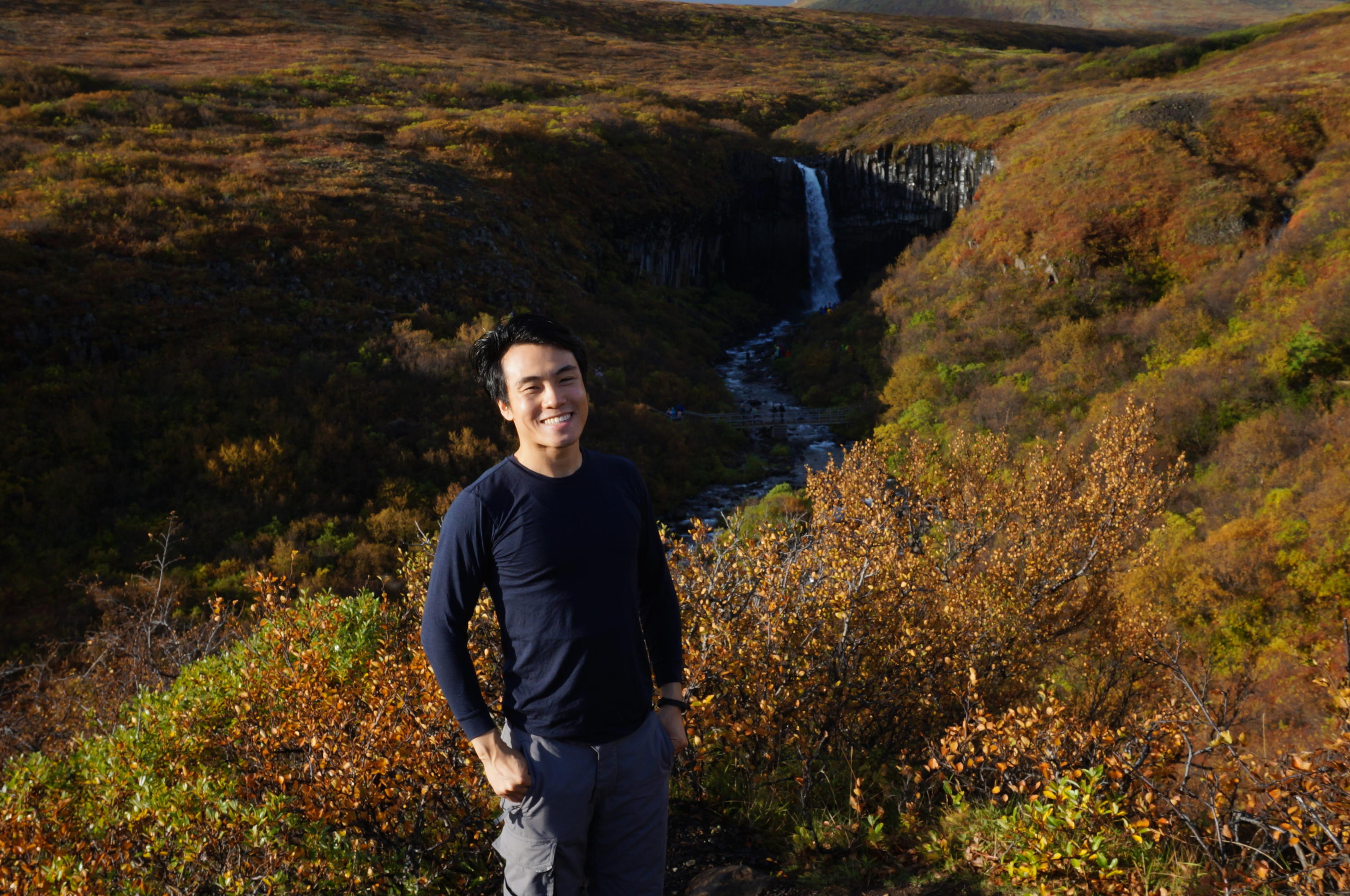 Marvin Ng in front of a waterfall