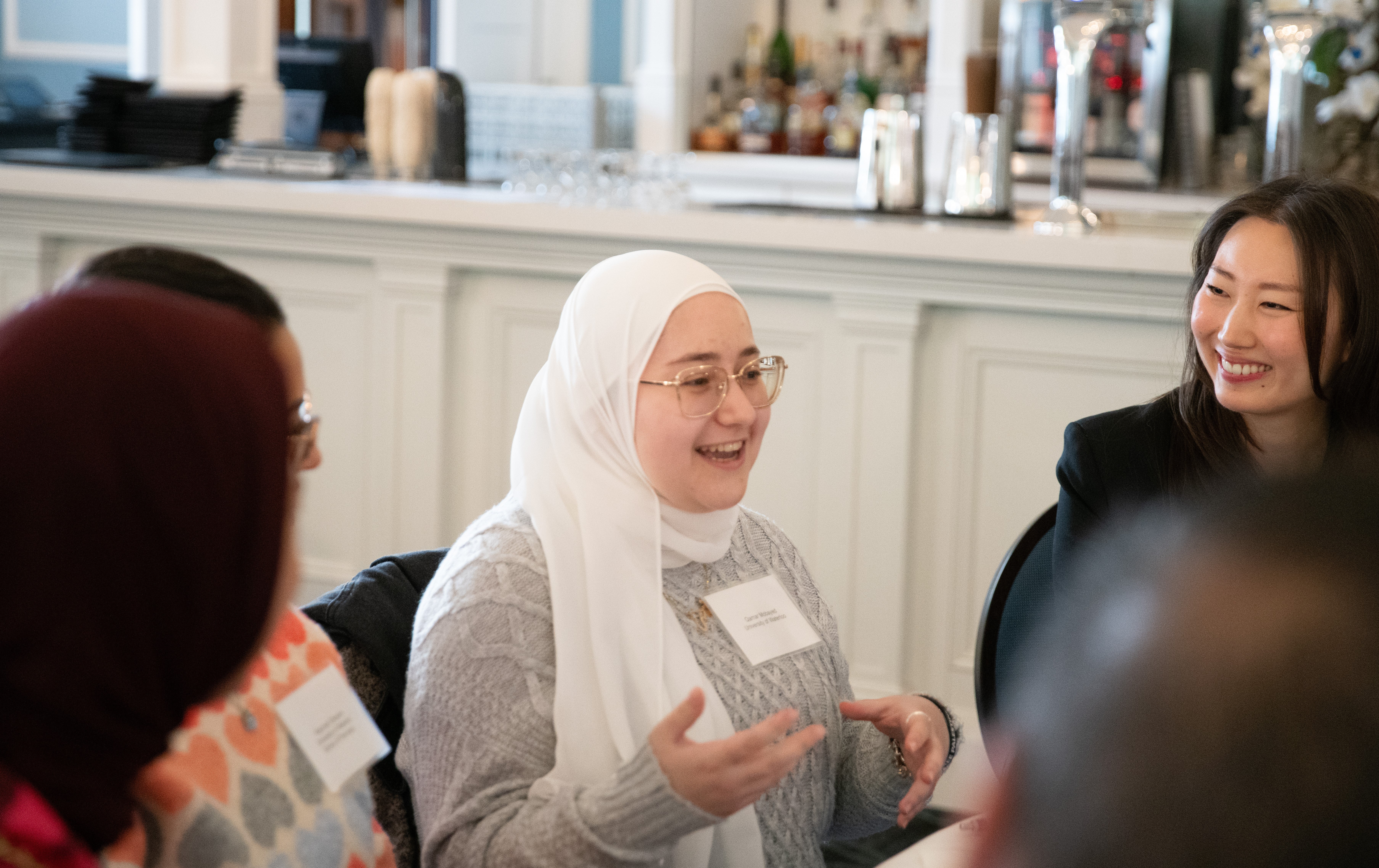 A student speaking to another table of professionals