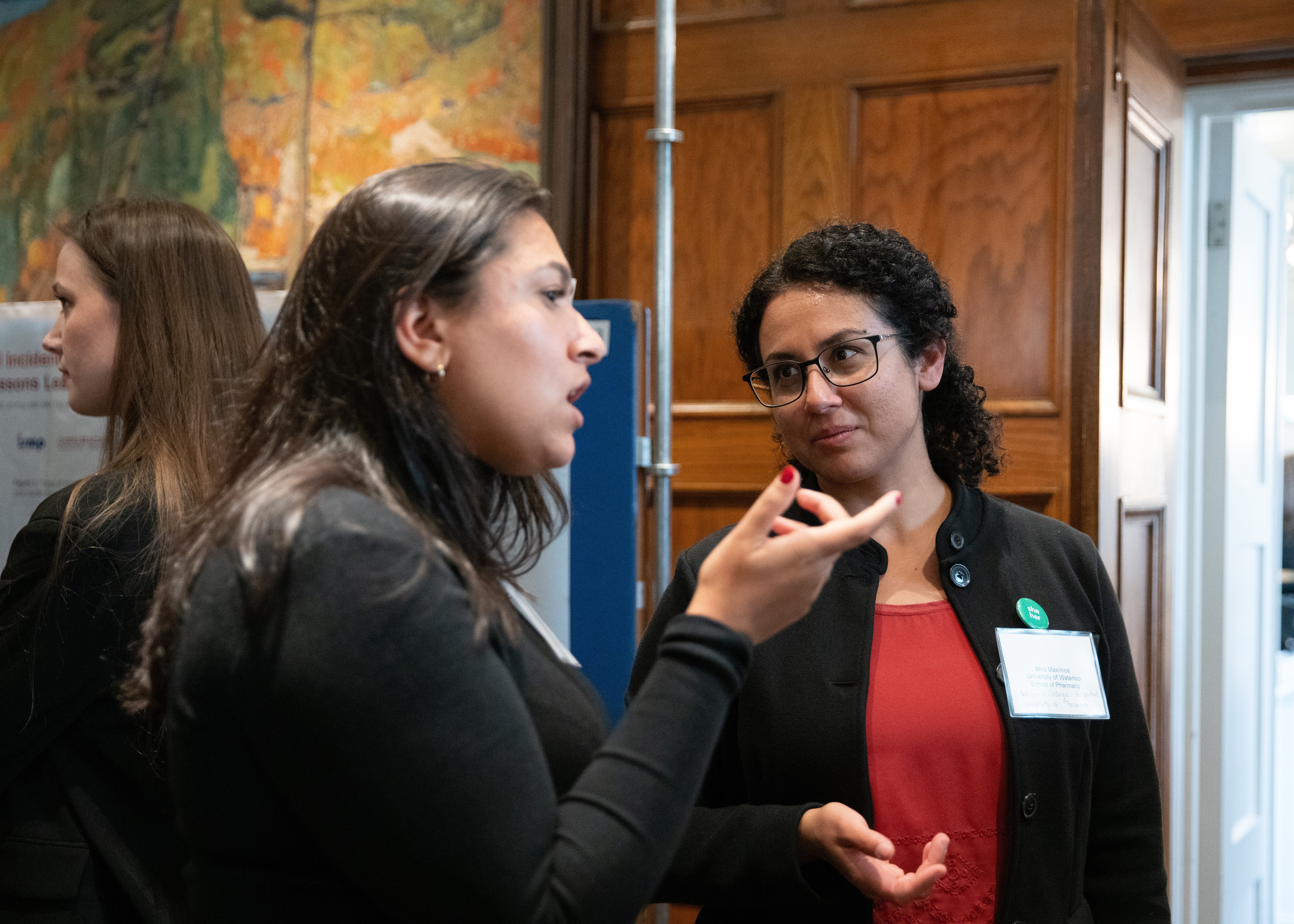 Mira Maximos speaking to a woman