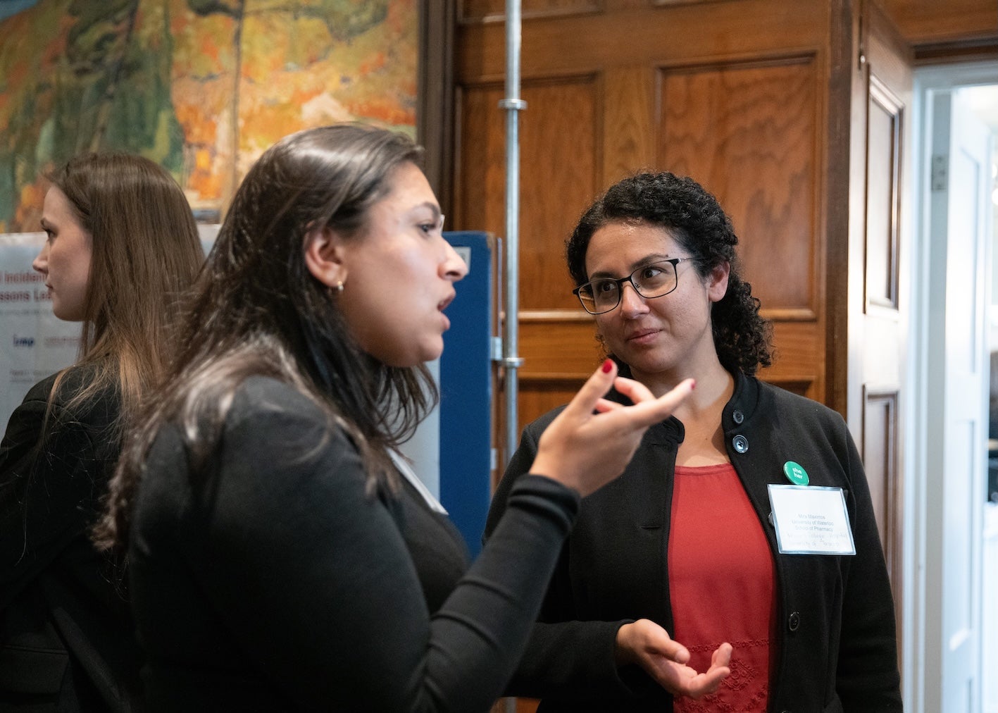 Mira Maximos speaking to a woman