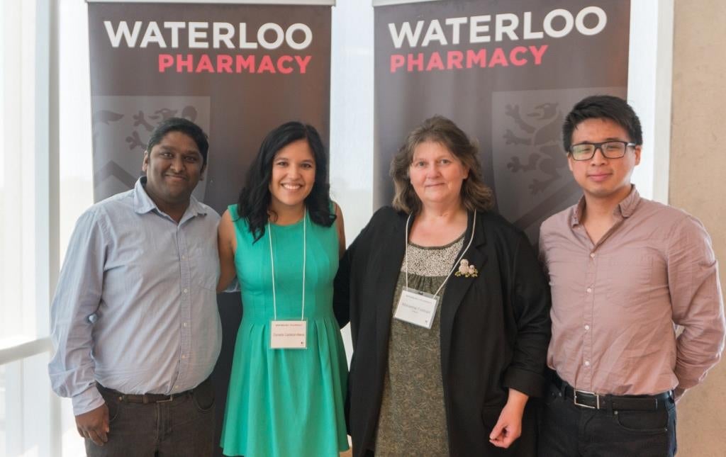 Lokesh, Daniella, Marianna and Ding-Wen (Roger) in front of Waterloo Pharmacy banners