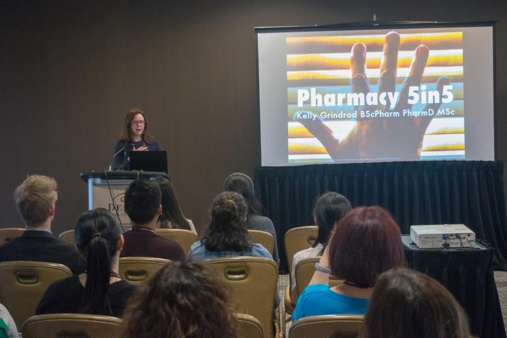 Kelly presenting on Pharmacy5in5 in front of crowd