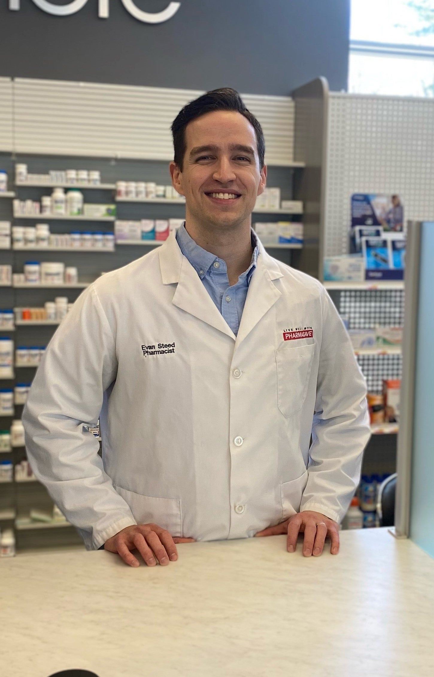 Evan Steed in his pharmacy smiling