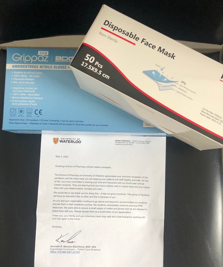 Donation package with gloves and masks and letter from the School of Pharmacy