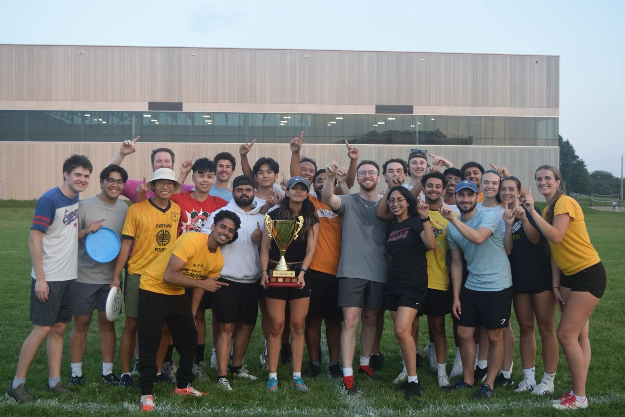 Frisbee team holding trophy