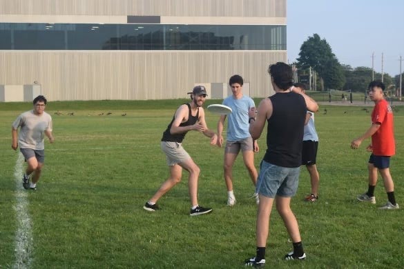 Students playing ultimate frisbee