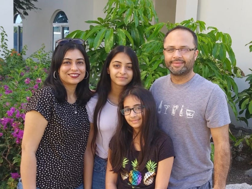 Sadaf and her two daughters and husband smiling