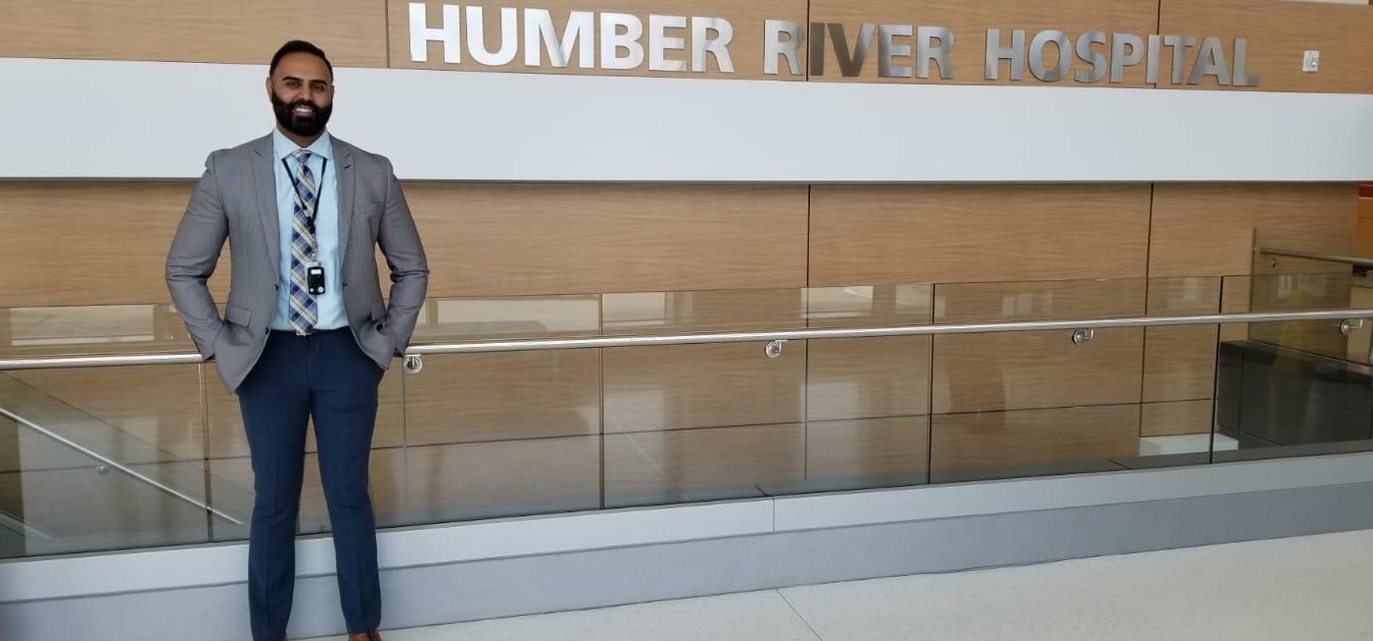 Gaganpal Mutti standing in front of a sign that says Humber River Hospital