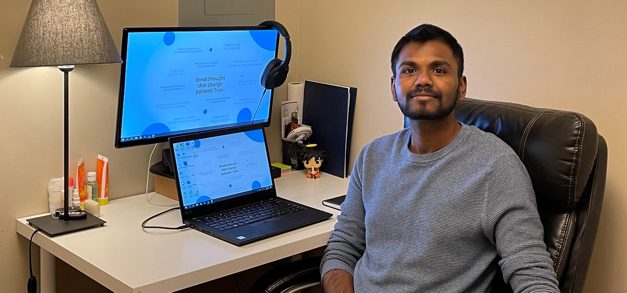 Gokul Pullagura sitting at computer in home office