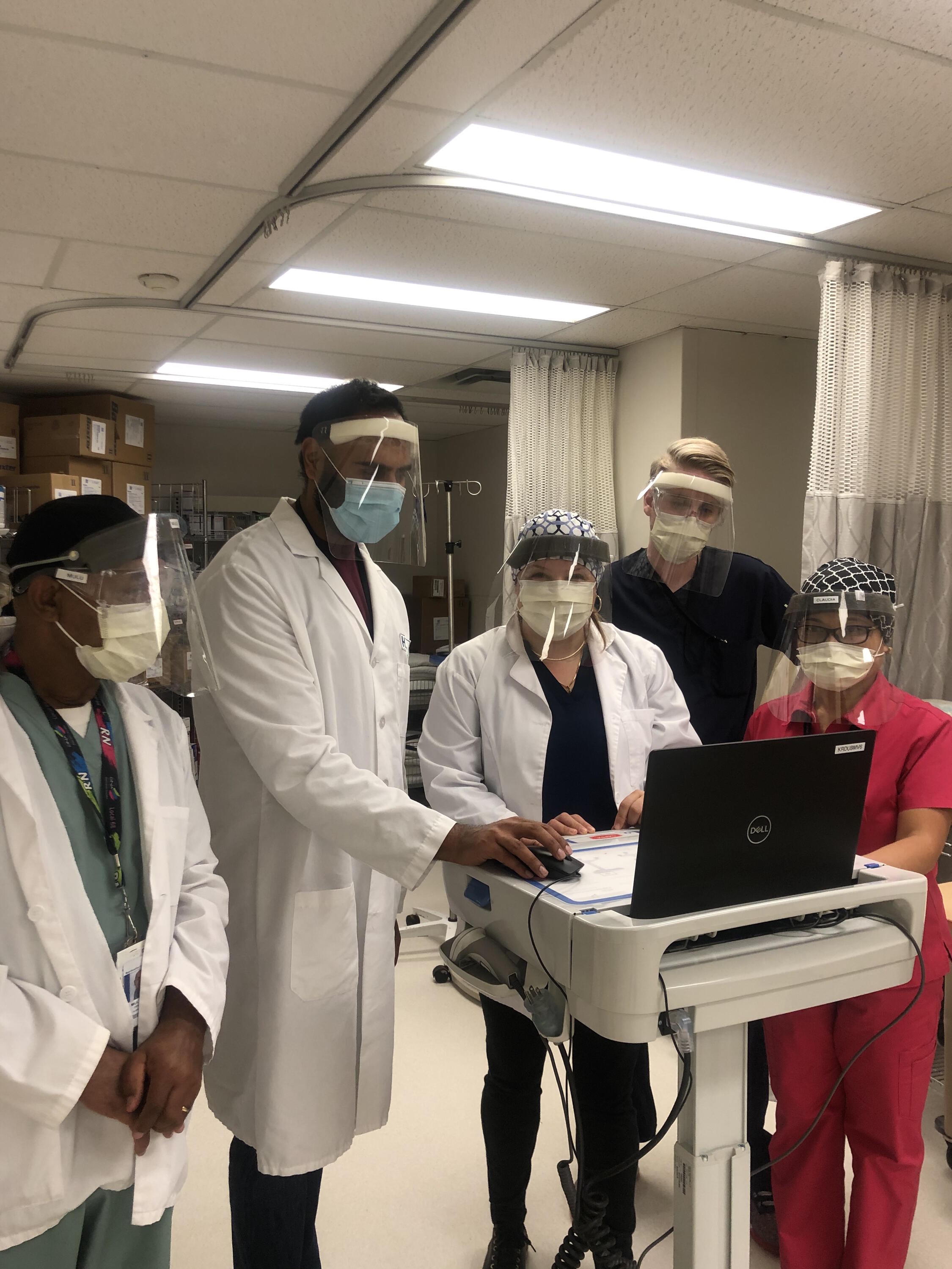 Gaganpal and team members standing in the hospital wearing PPE