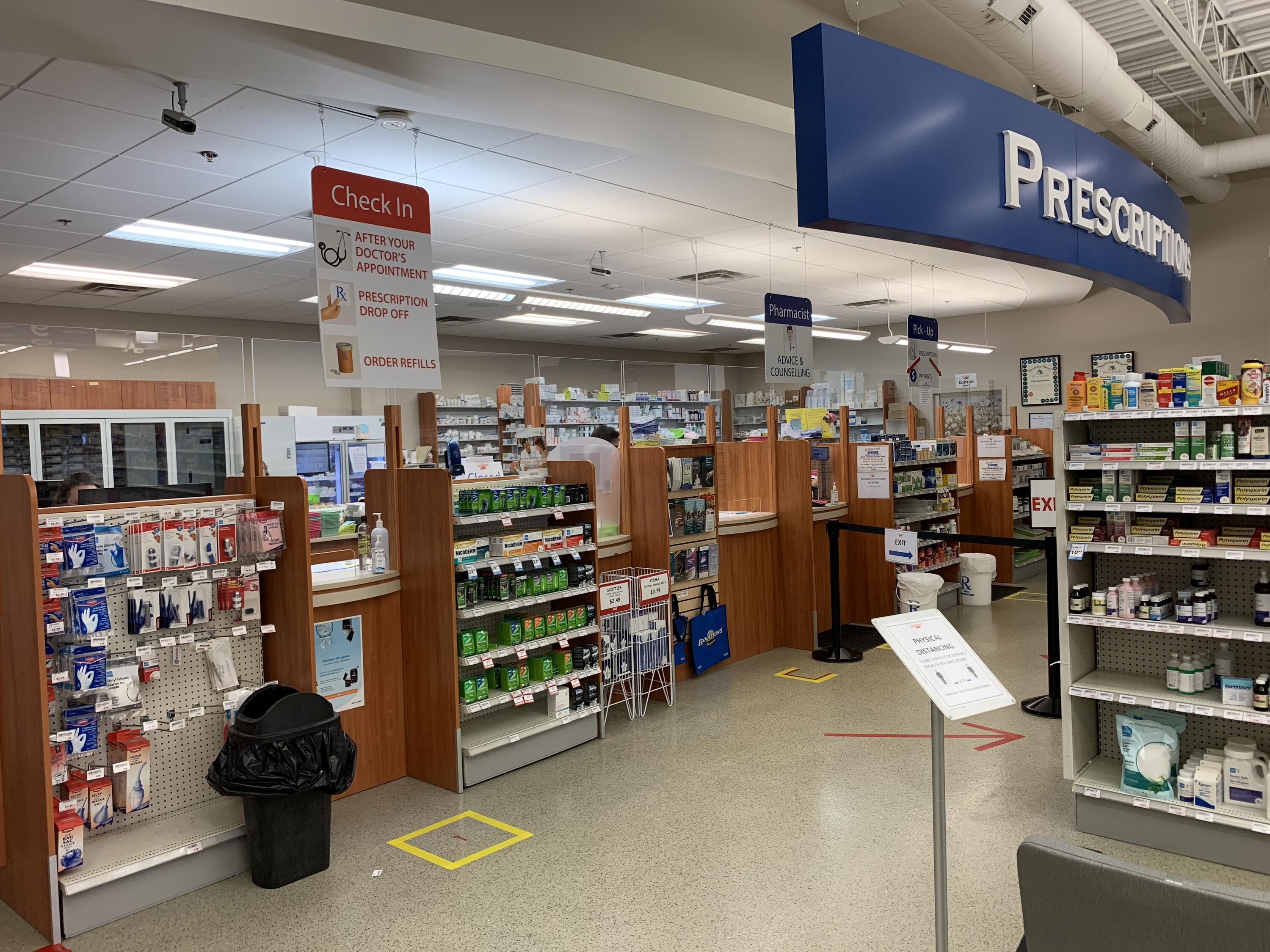 Pharmacy with wide aisles and tape on floor 
