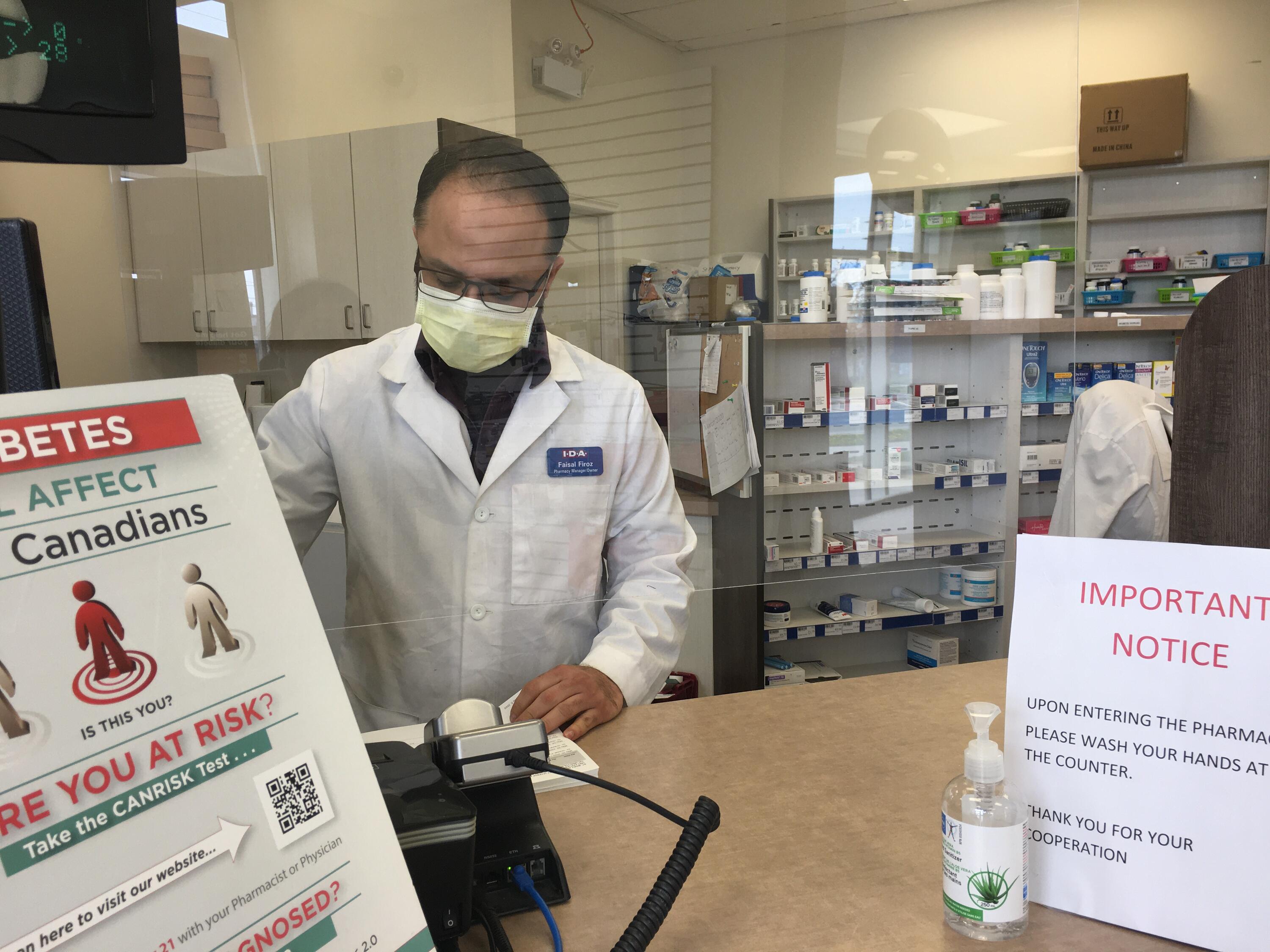 Faisal working at the pharmacy counter
