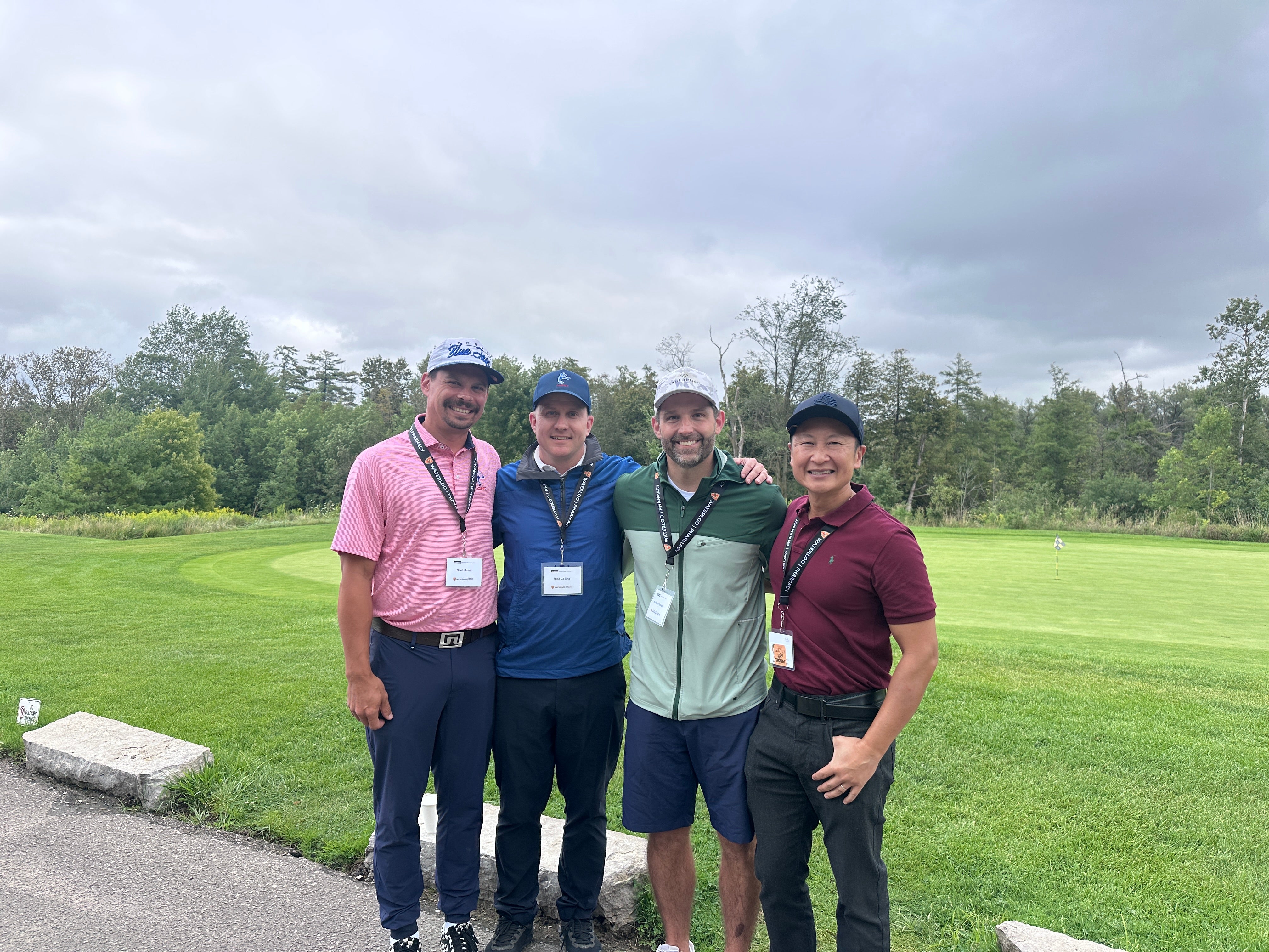 Four men smiling together