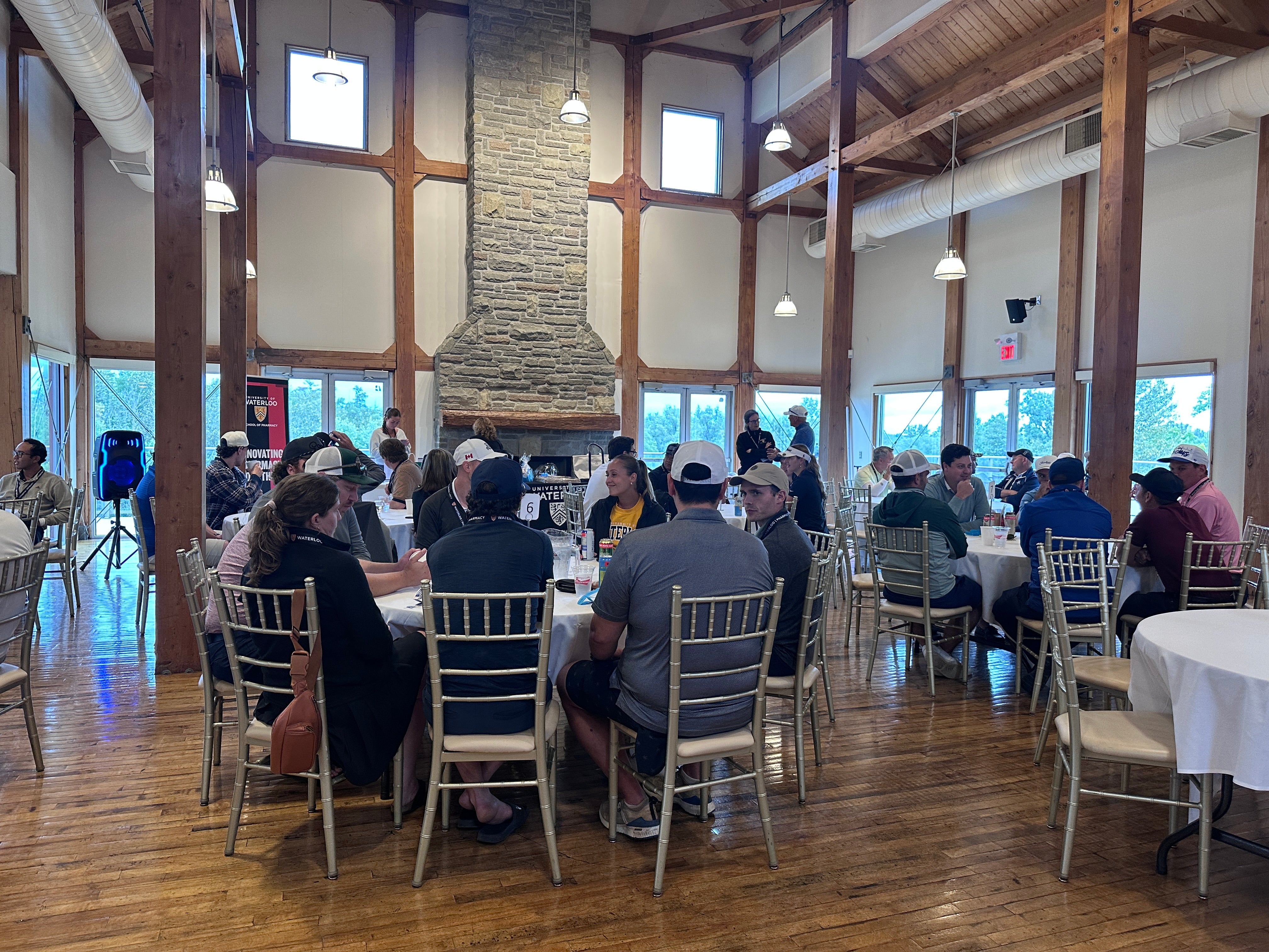 Several tables with people seated around the room