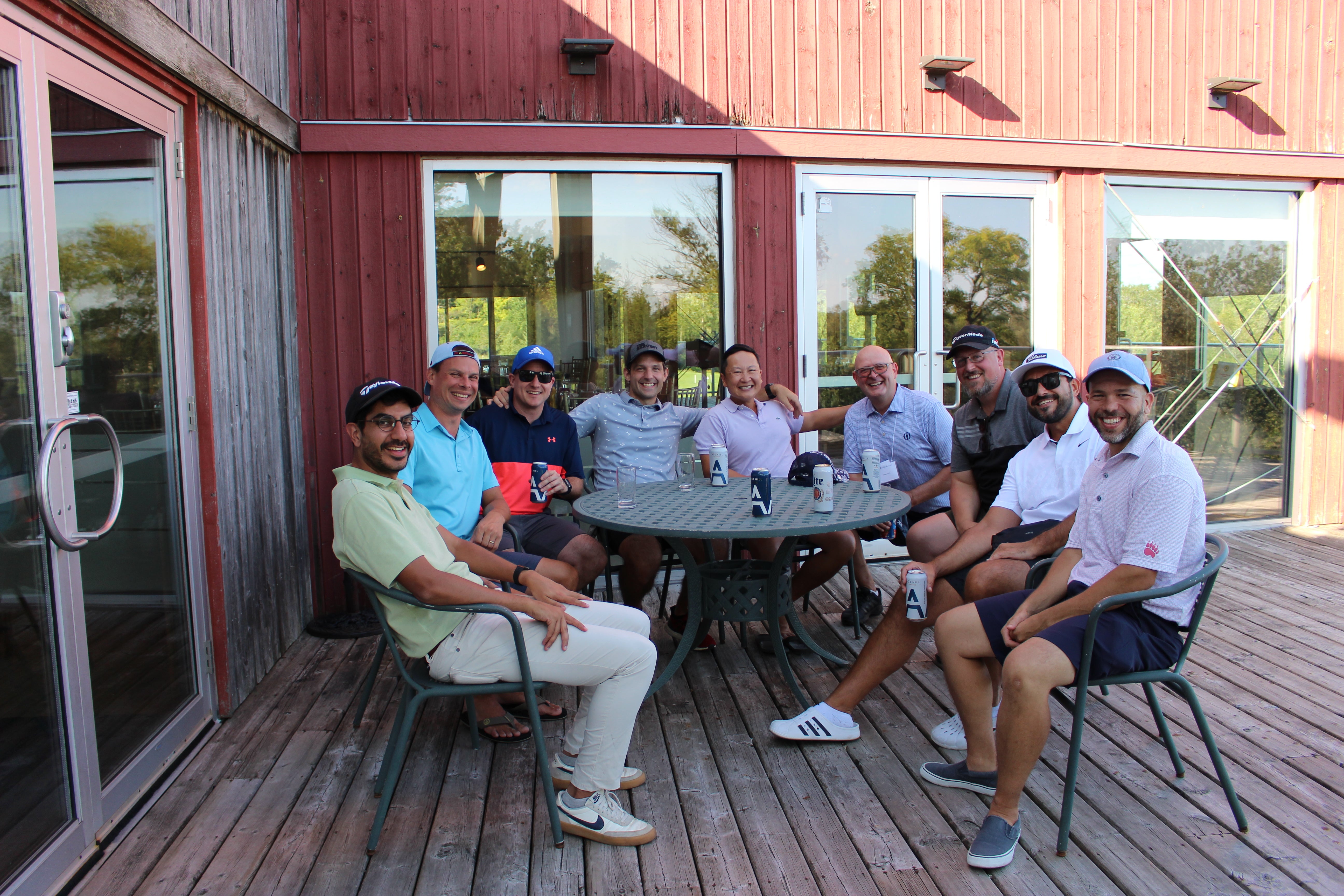 Alumni sitting at table and smiling