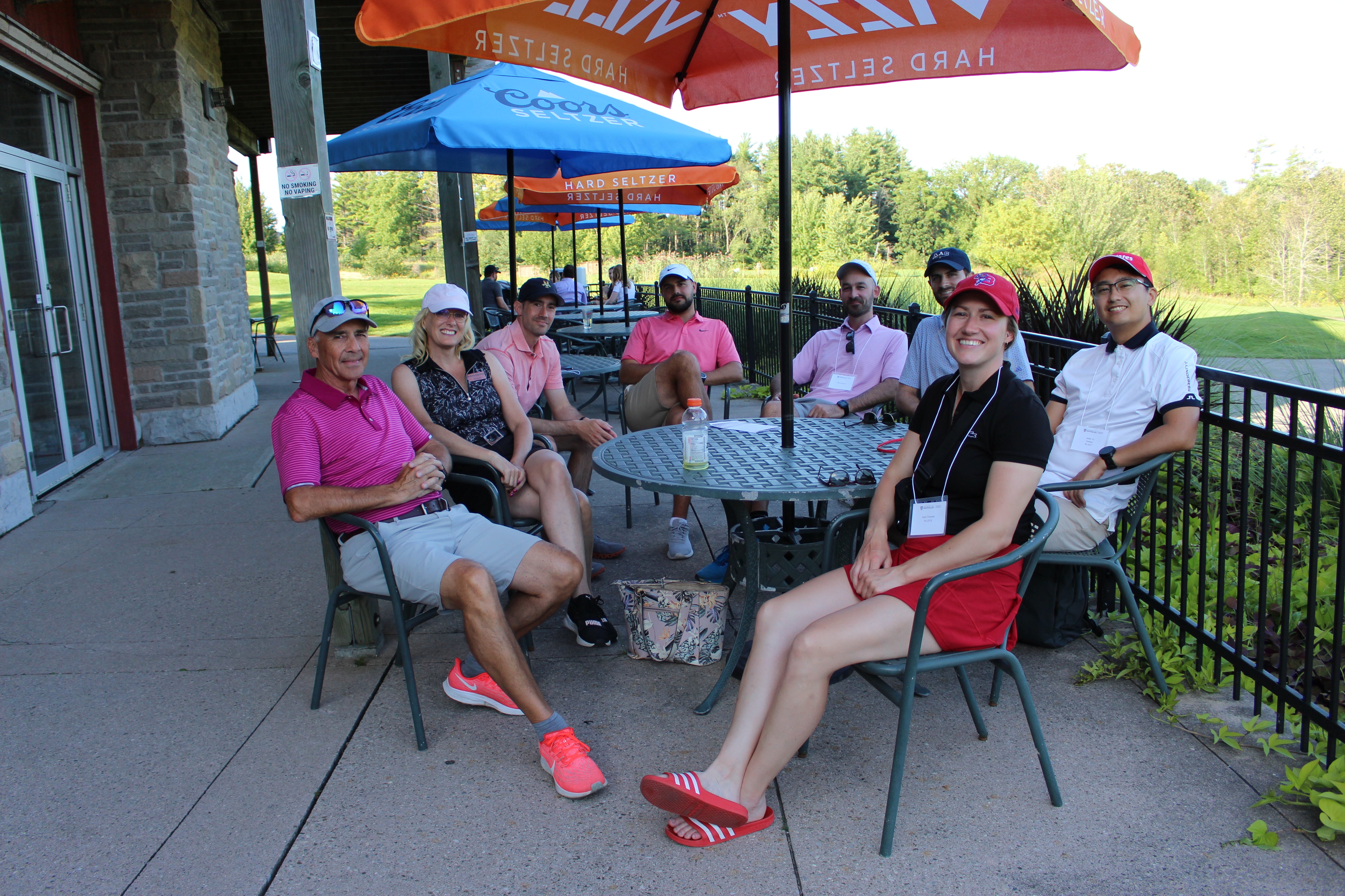 Alumni sitting around a table smiling