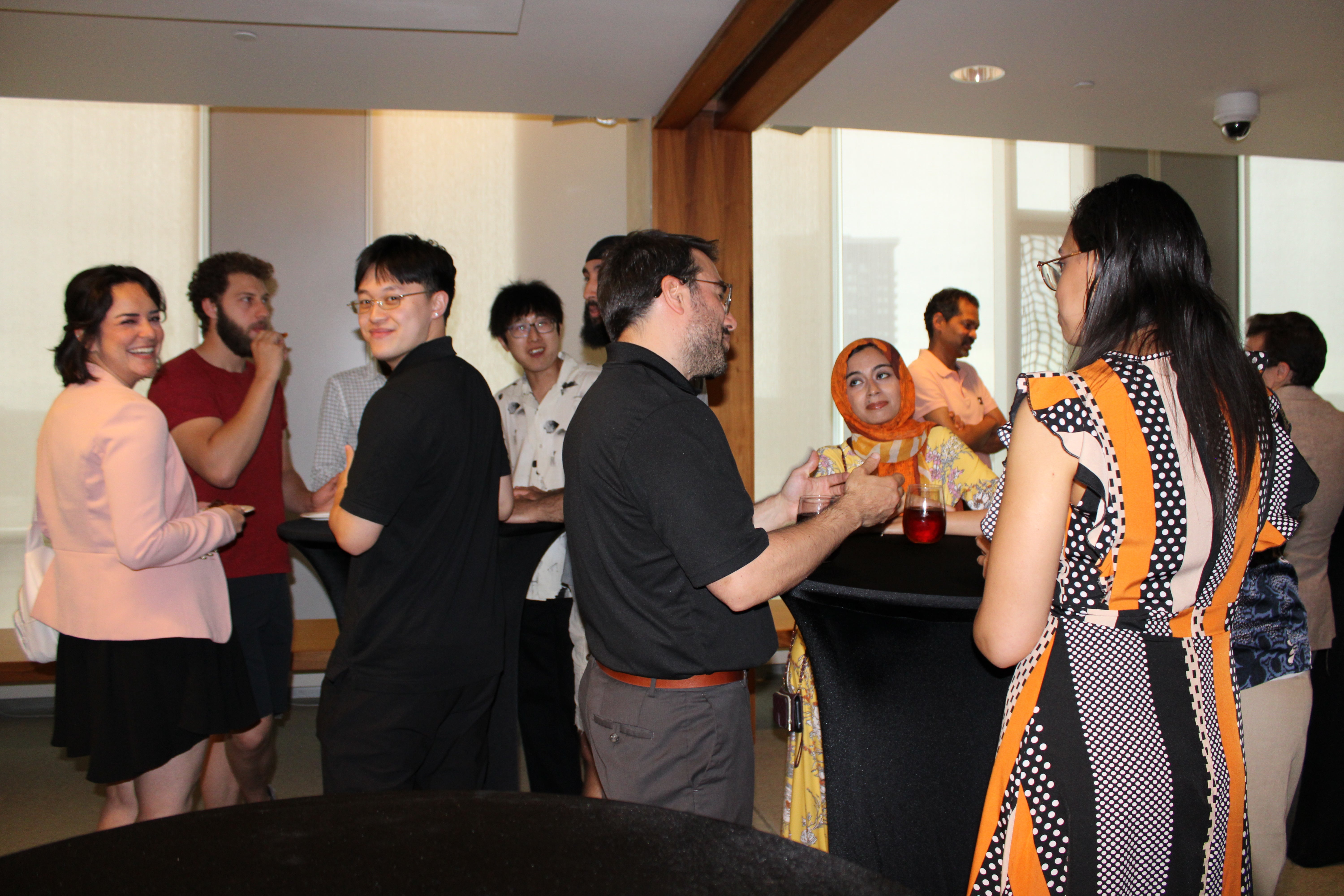 A group of people talking among one another at an event