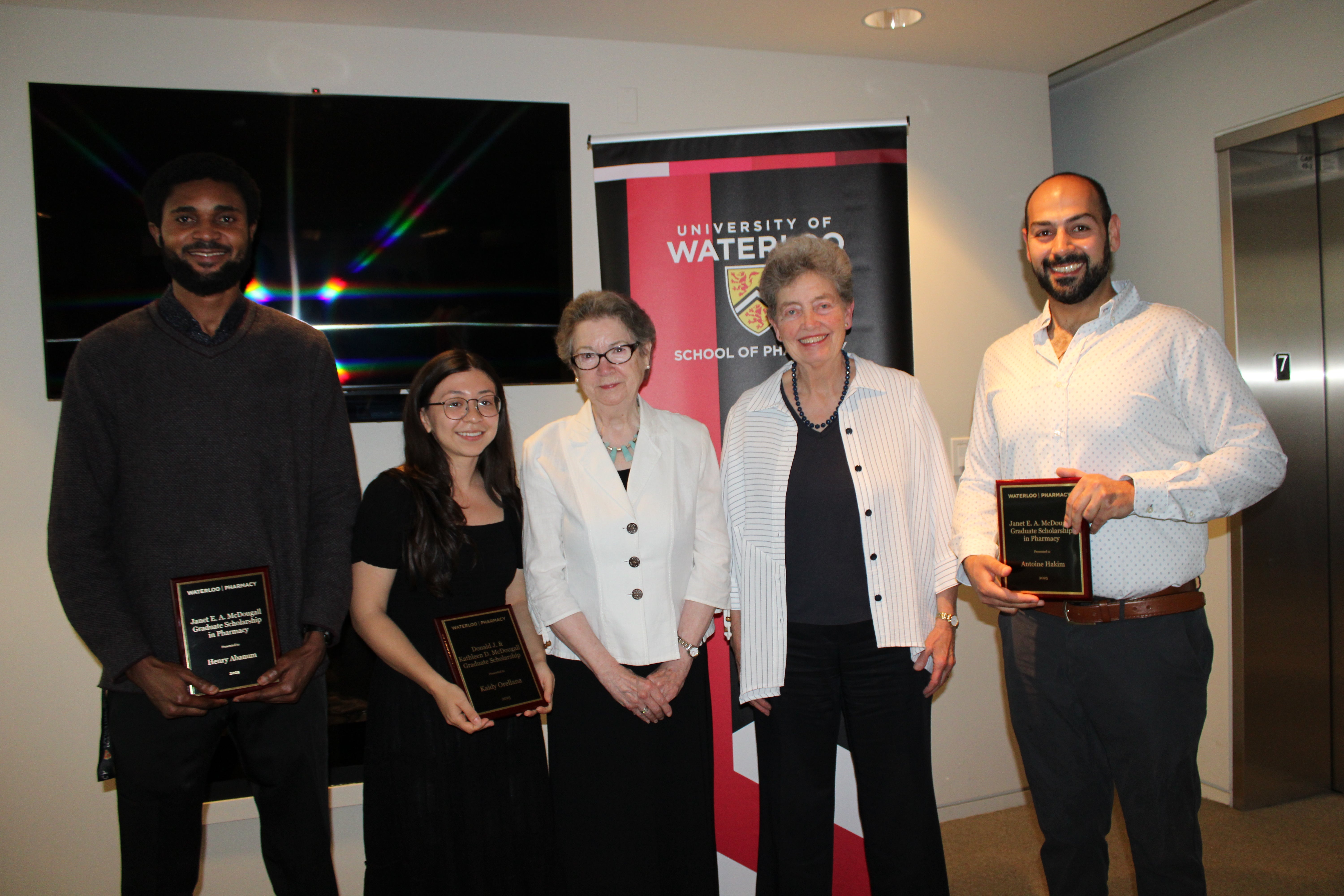 Group of people smiling holding awards