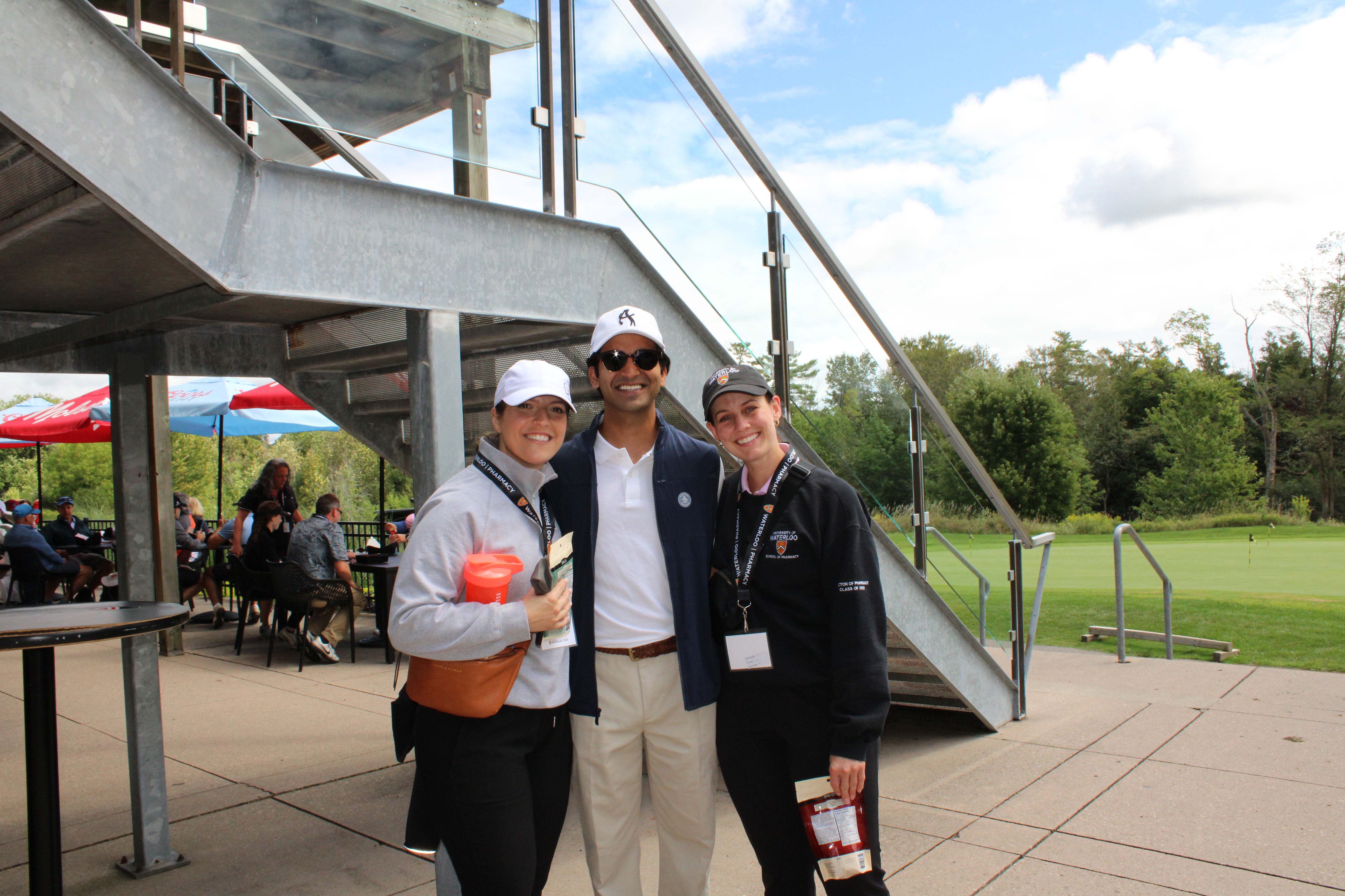 Three people smiling