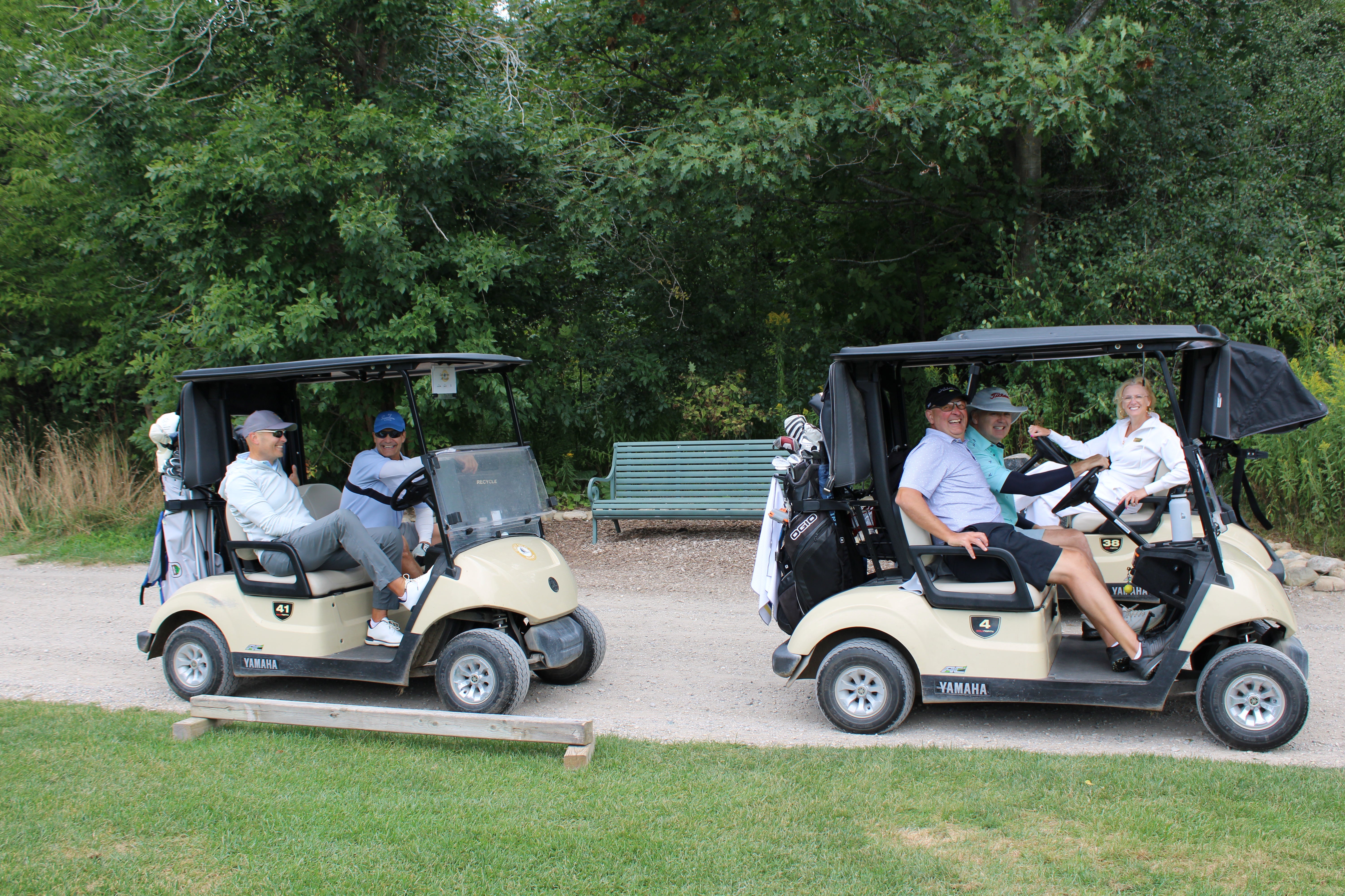 People in golf carts smiling
