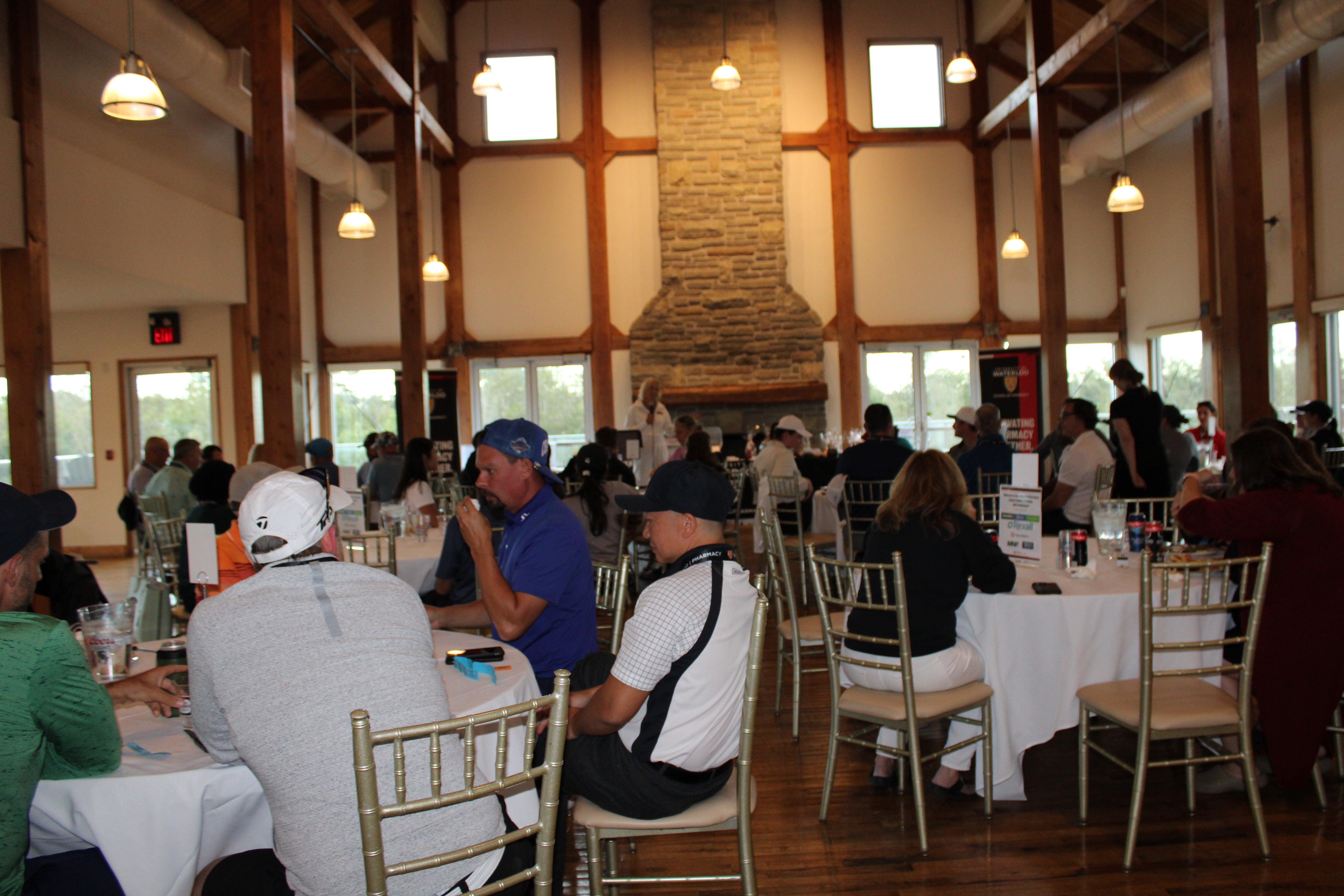 A group of people sitting around tables chatting