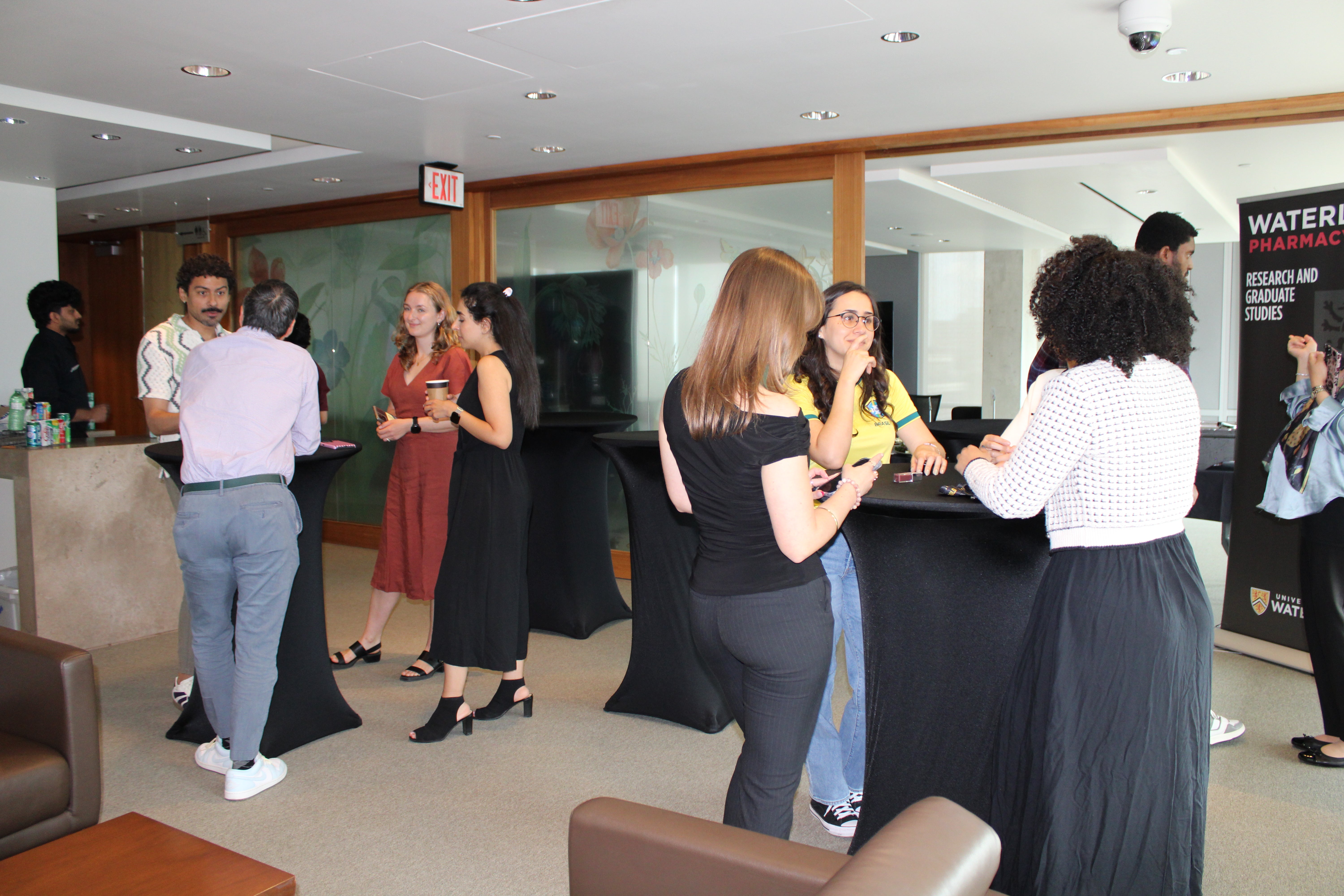 Students and faculty in conversation in a campus lounge