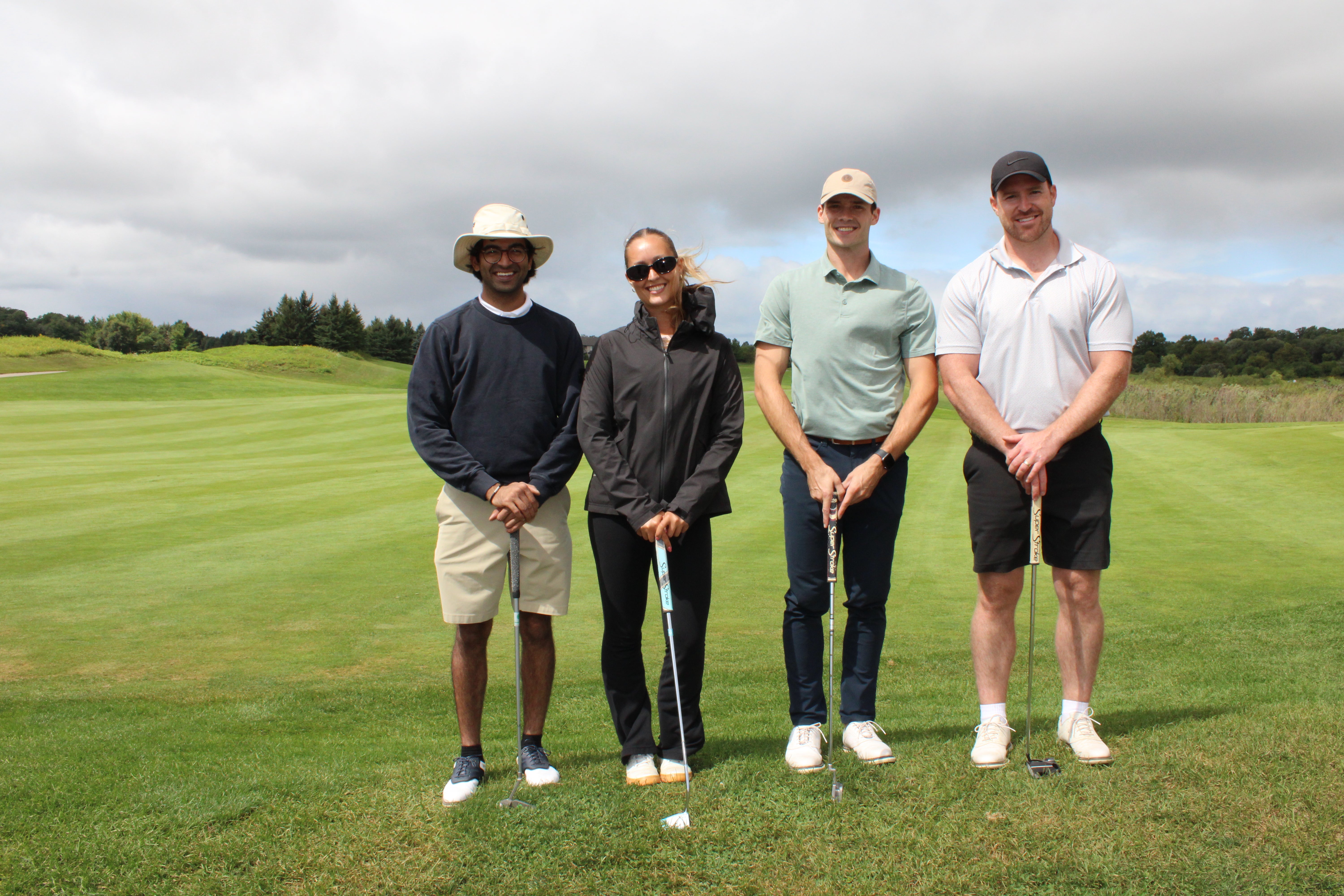 Golf group of four smiling on the green