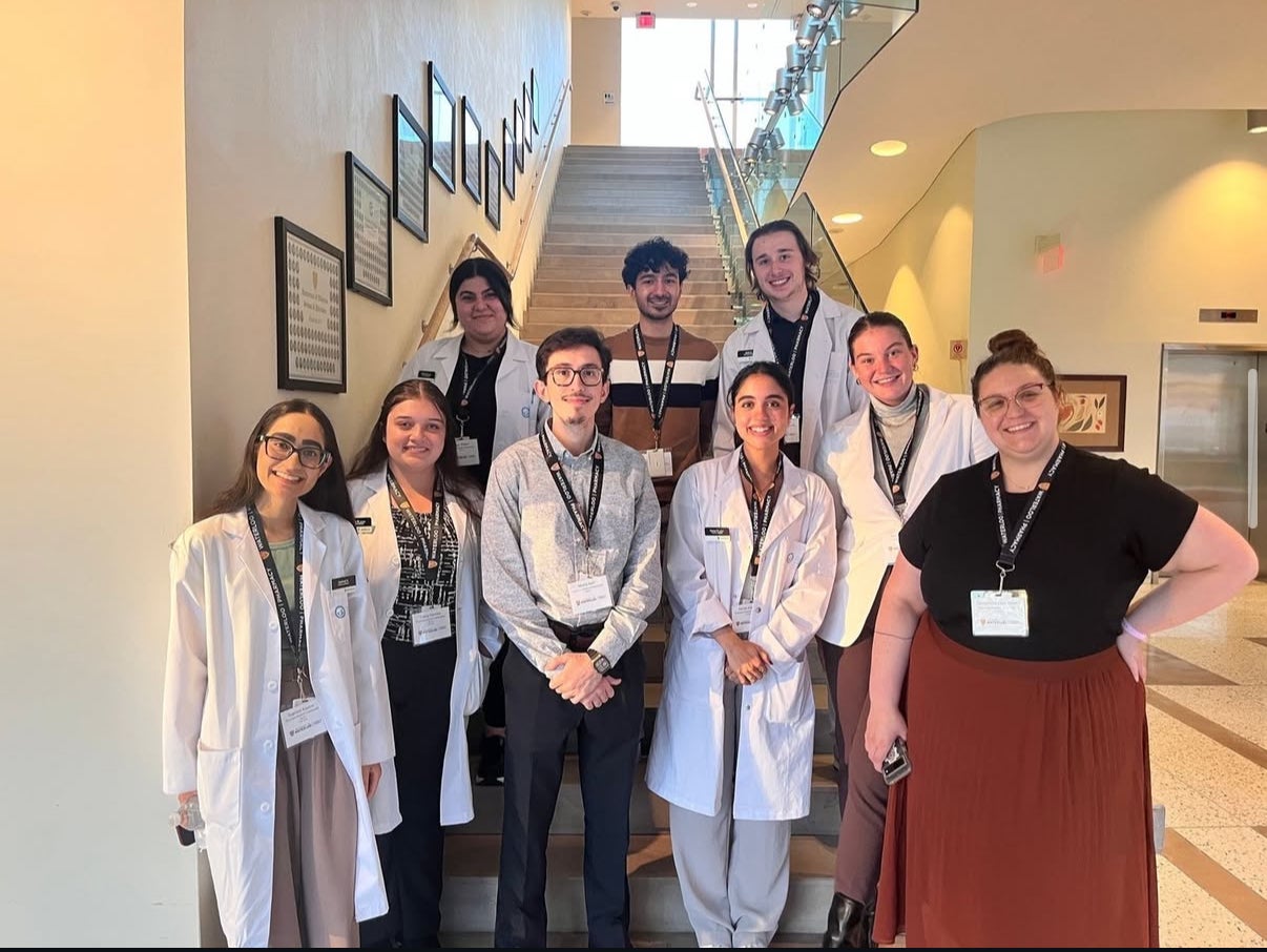 Student ambassadors standing on stairs in a group photo