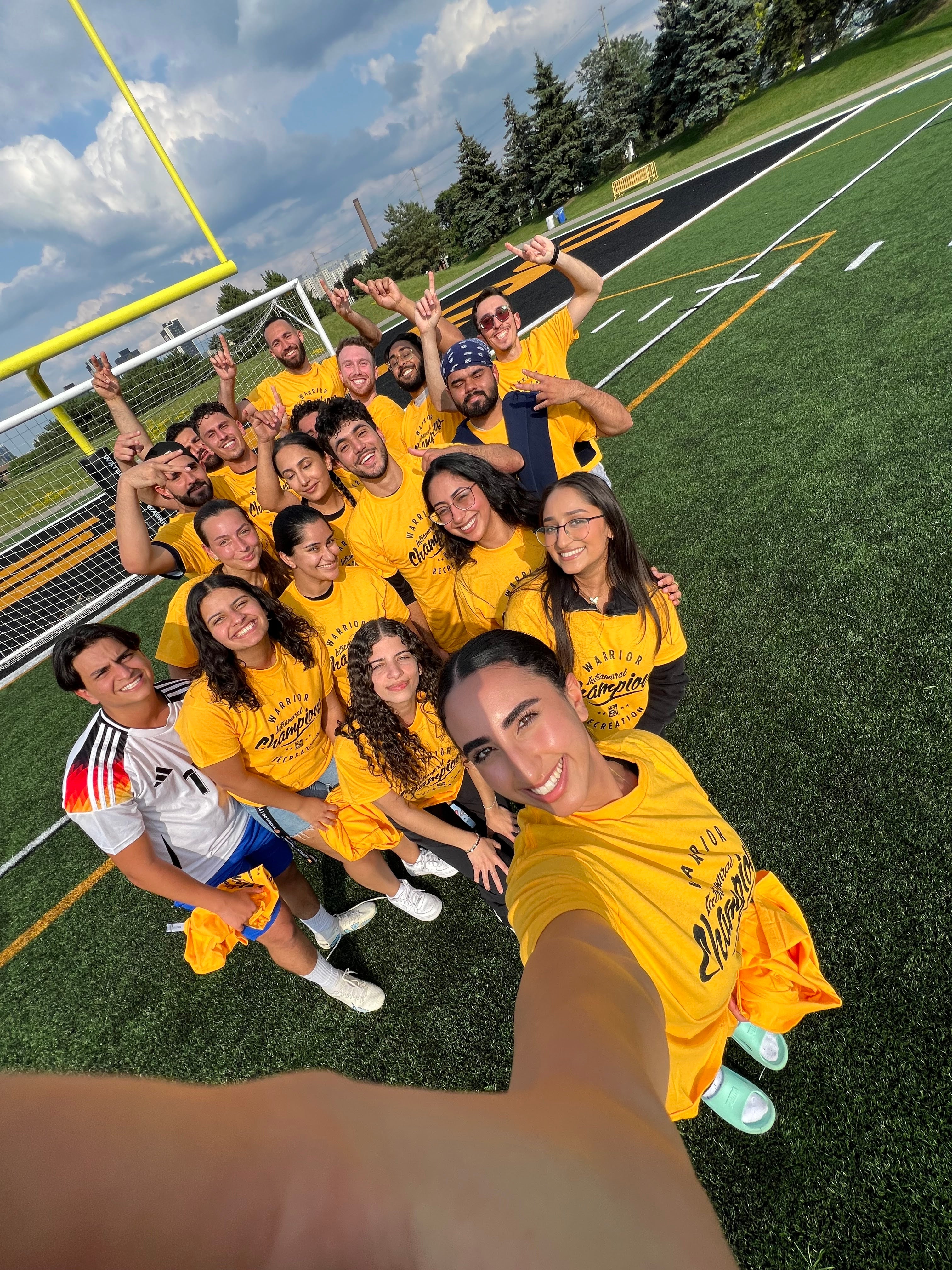 Student taking a selif of her and her soccer team