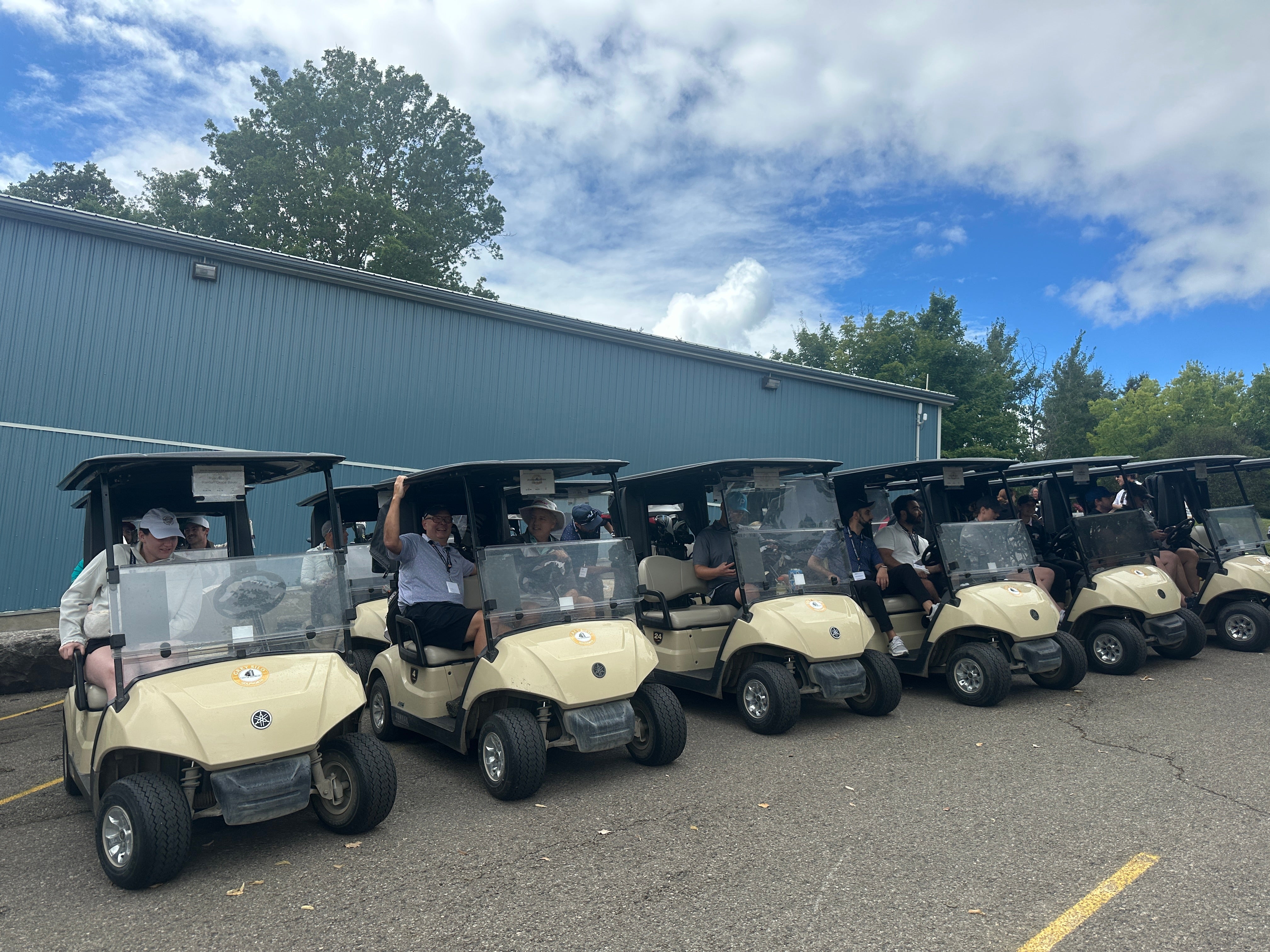 Golf carts lined up with people in them