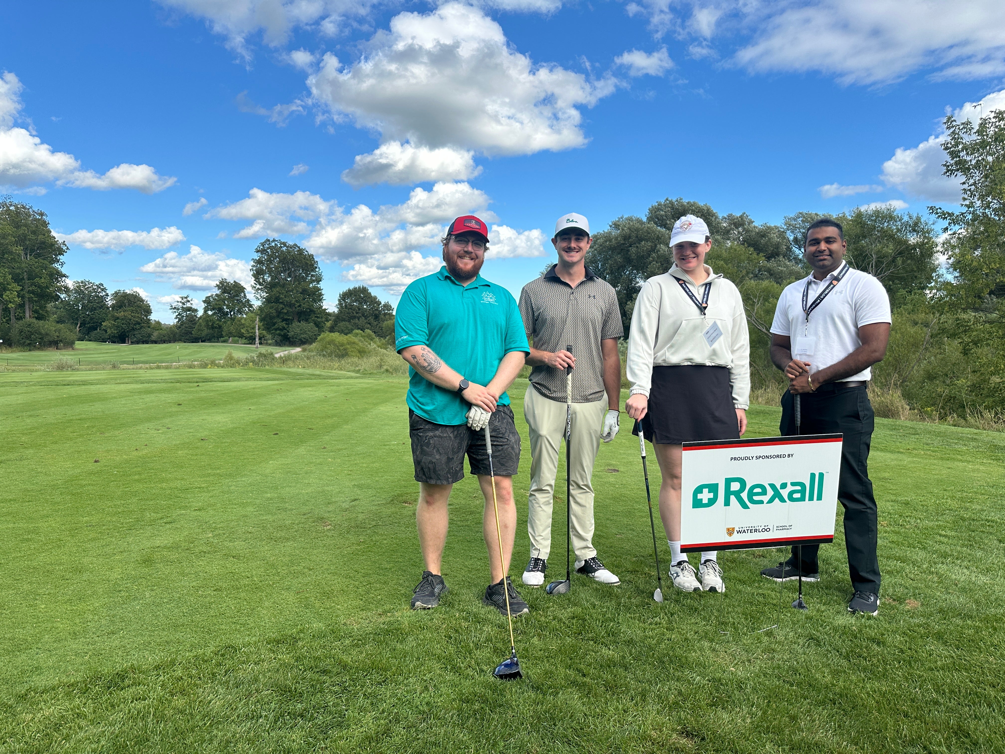 Group of people smiling on the golf course 
